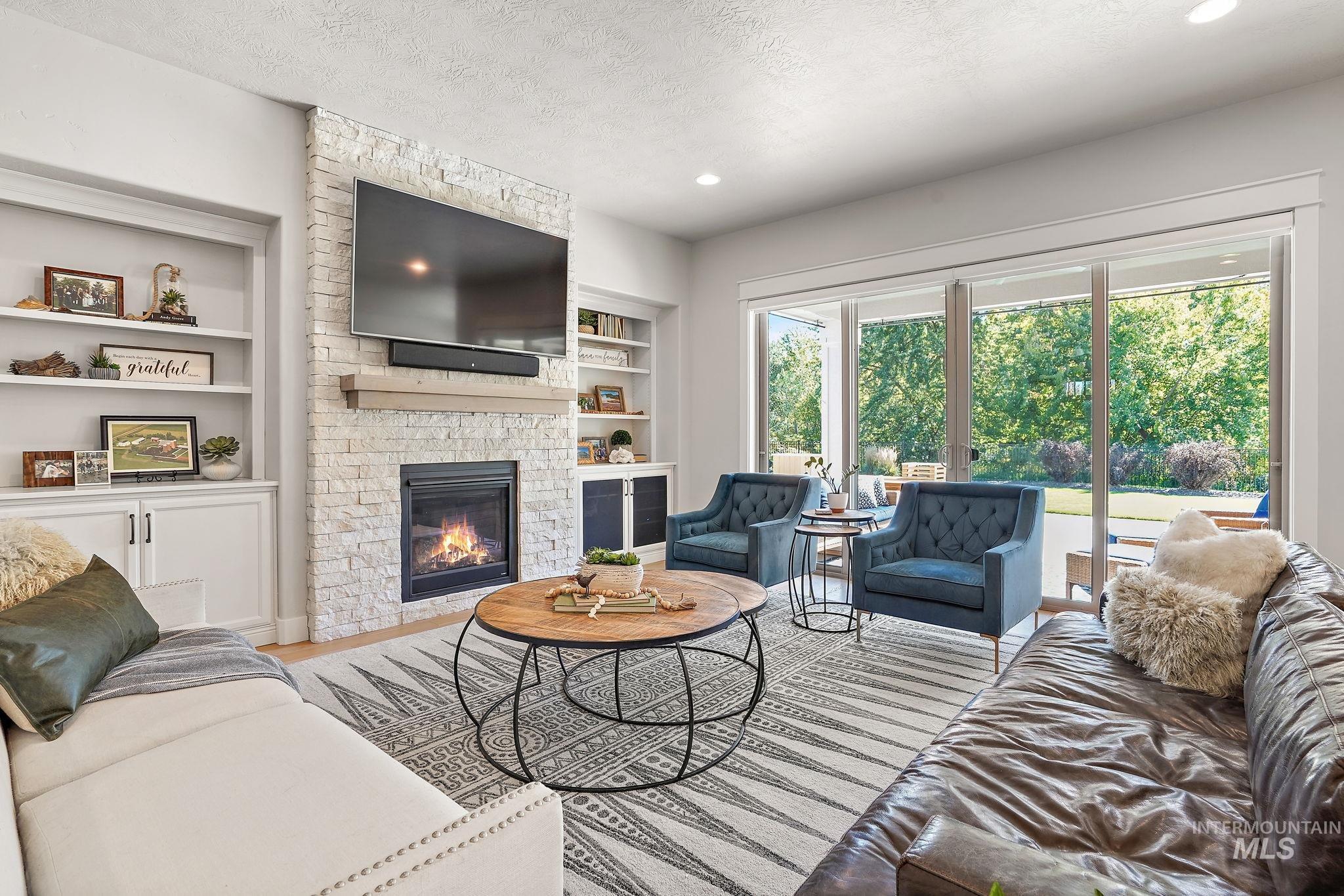 Cozy fireplace, wood finished floors, and recessed lighting
