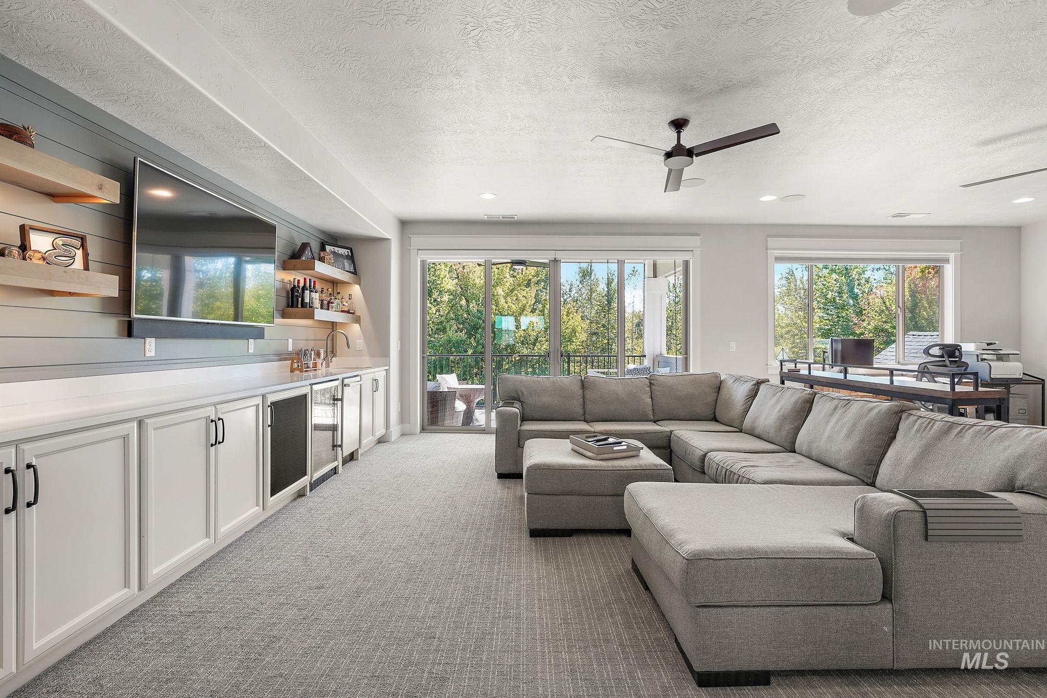 Built-in shelving & cabinets with sink, mini fridge & dishwasher.