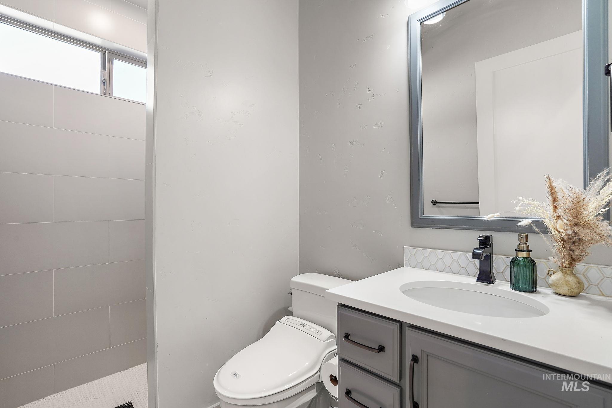 Main level bathroom with vanity & walk-in zero threshold shower
