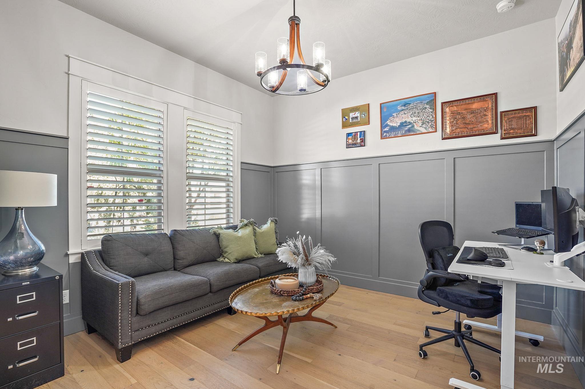 Main level office with storage closet and hardwood floors