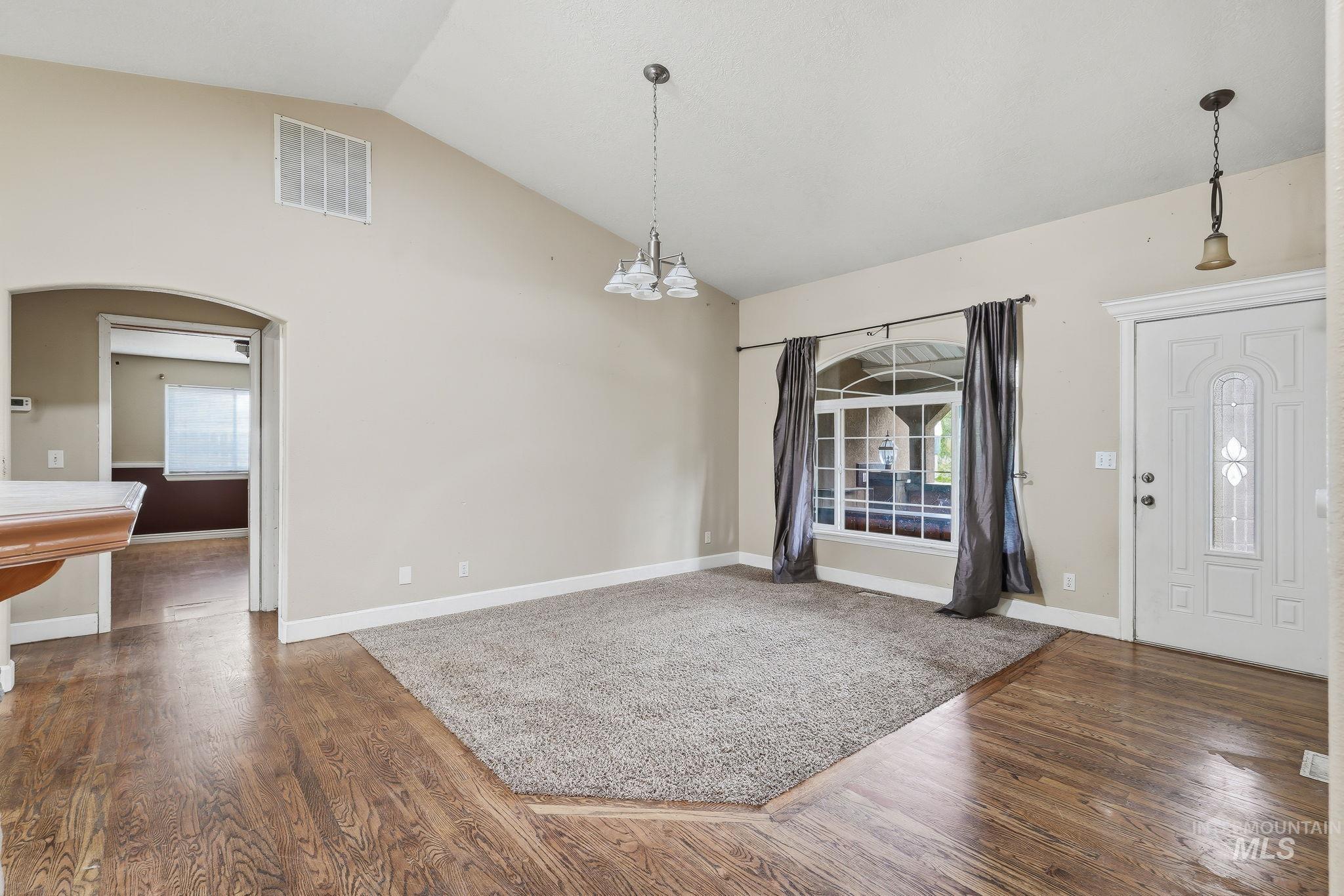 Vaulted ceilings complement the wood-finish flooring and neutral wall tones