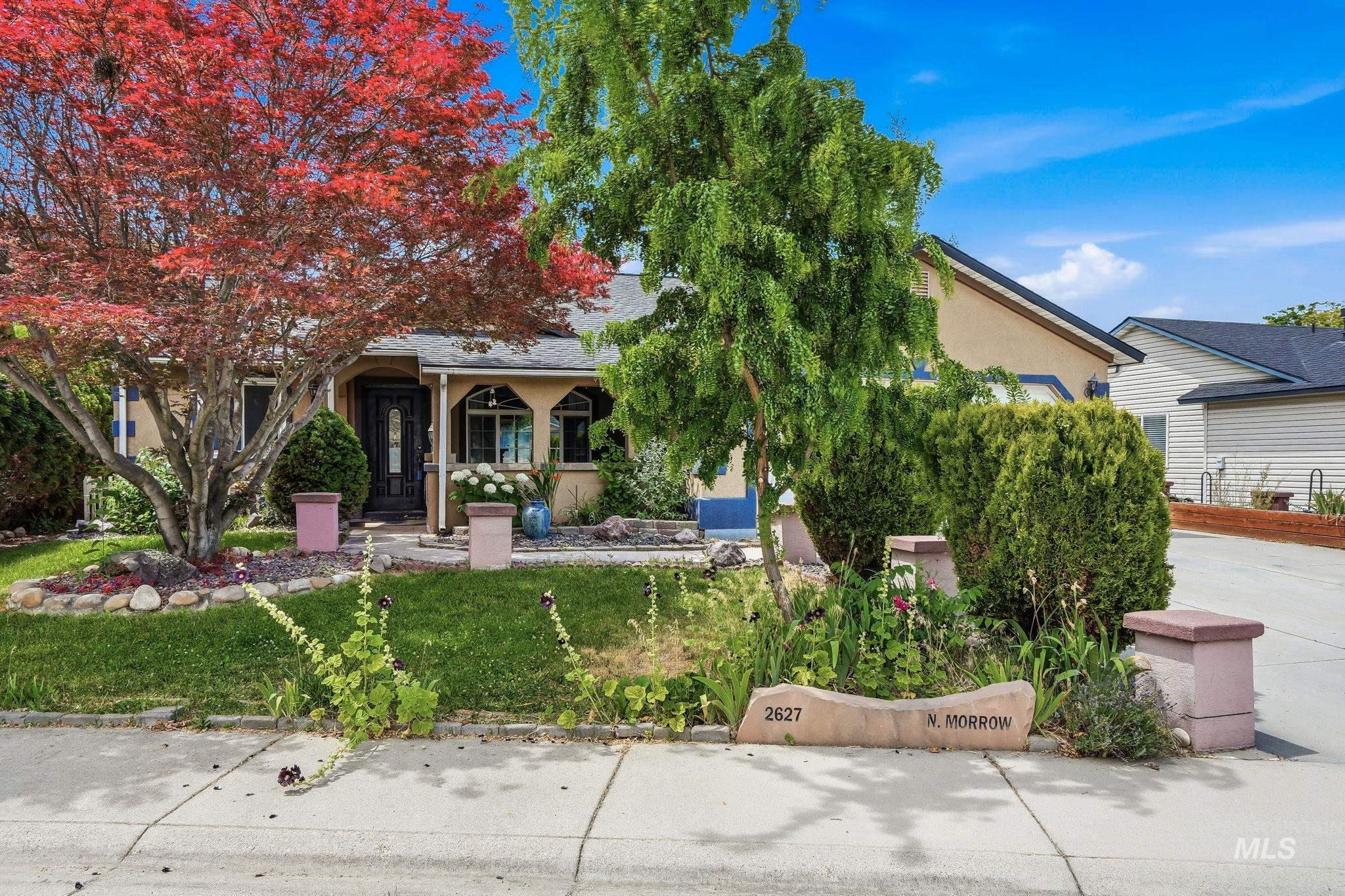 Front exterior featuring a covered entry, stucco siding, and a dark asphalt shingle roof