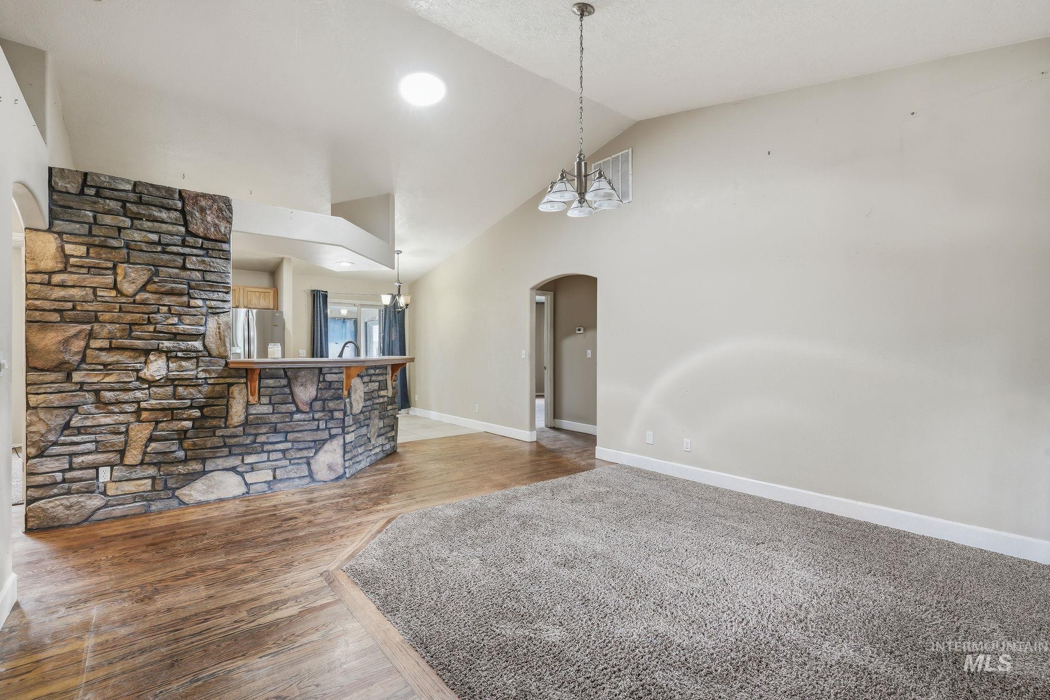 Stone-clad half-wall with a wood-finish bar top