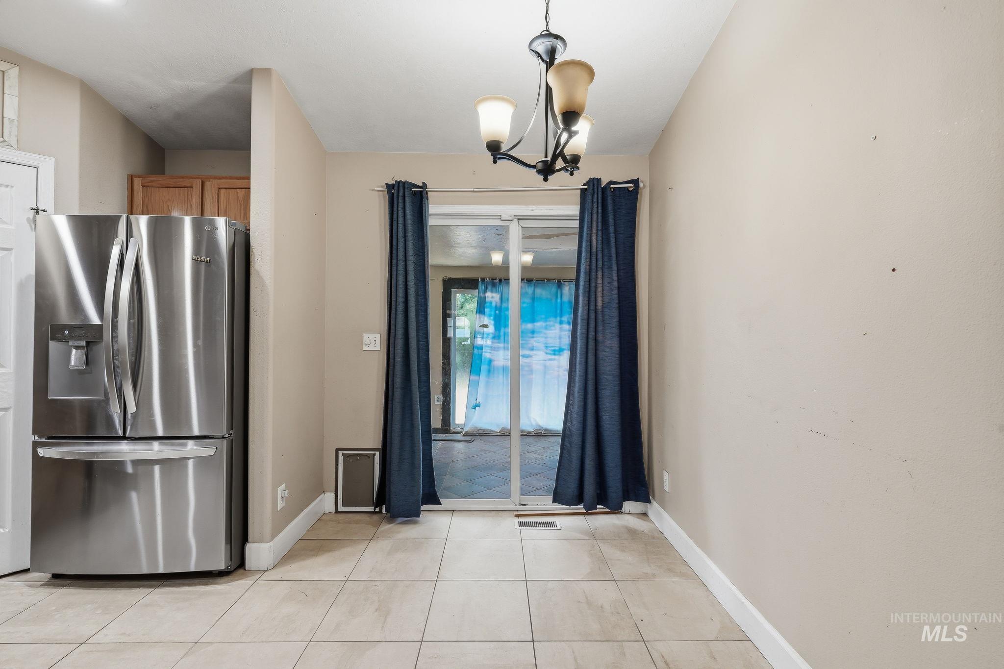 Dining area featuring neutral wall tones and tiled flooring