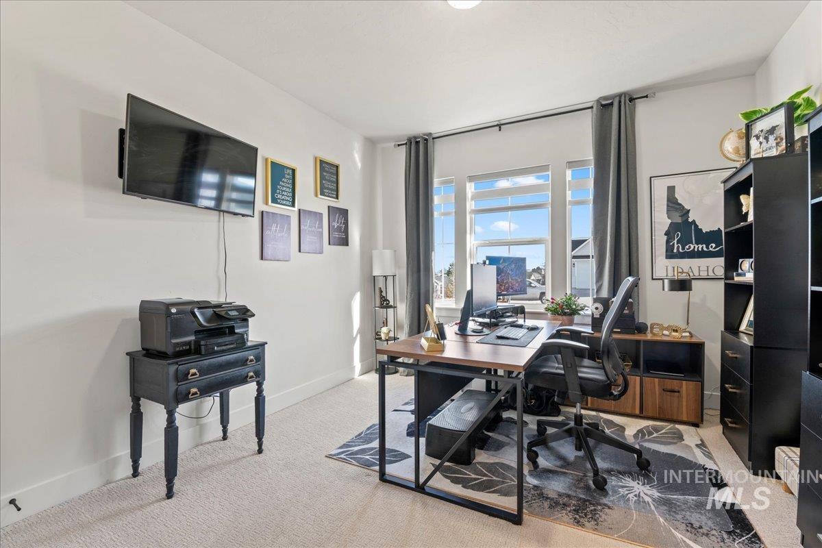 Home office with light carpet