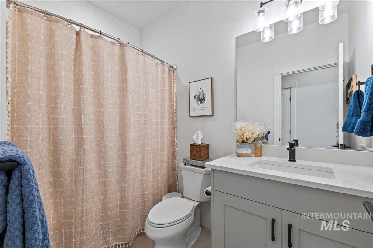 Full bathroom featuring vanity and curtained shower