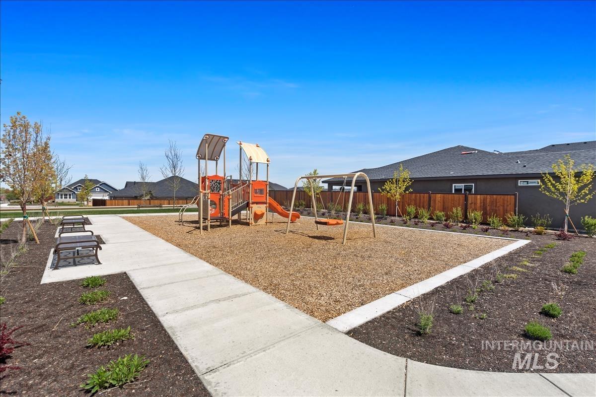 Community jungle gym with a residential view