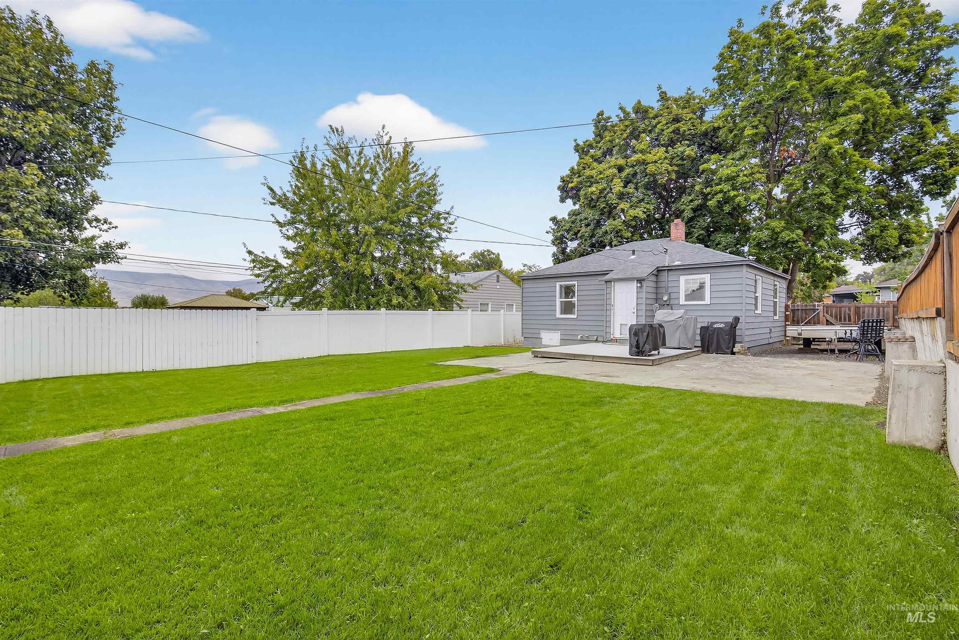 Fenced backyard featuring a patio