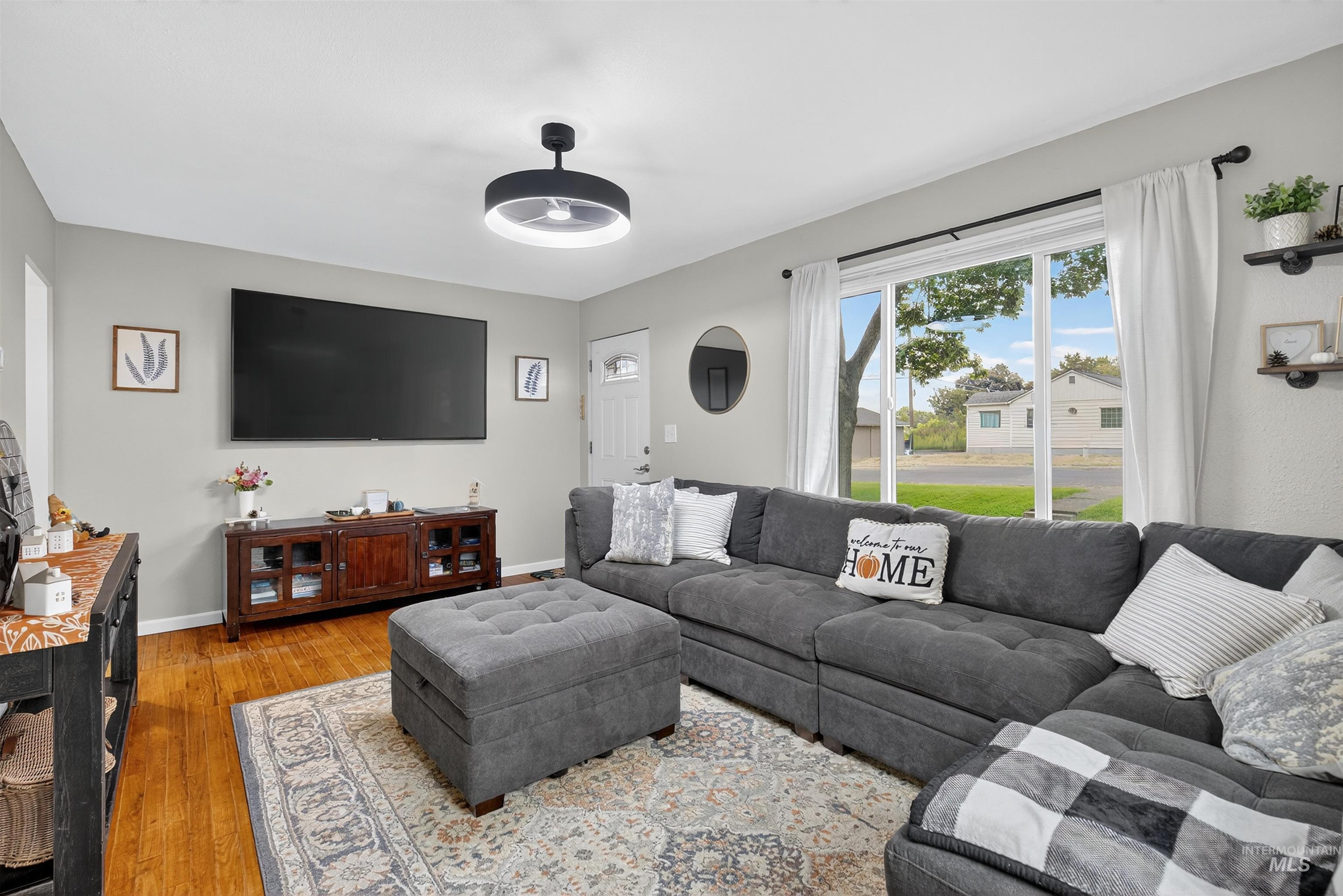 Living area with wood finished floors and baseboards
