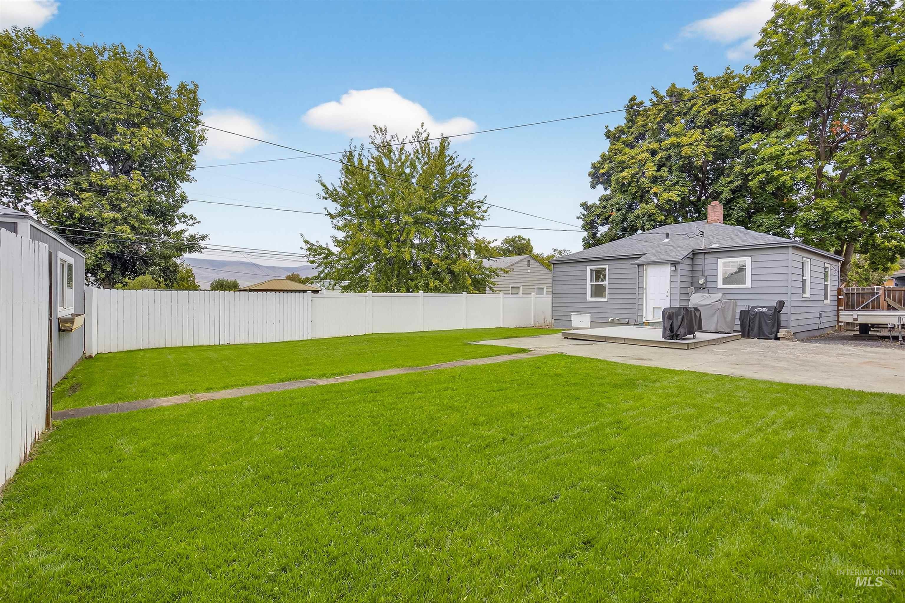 Fenced backyard featuring a patio