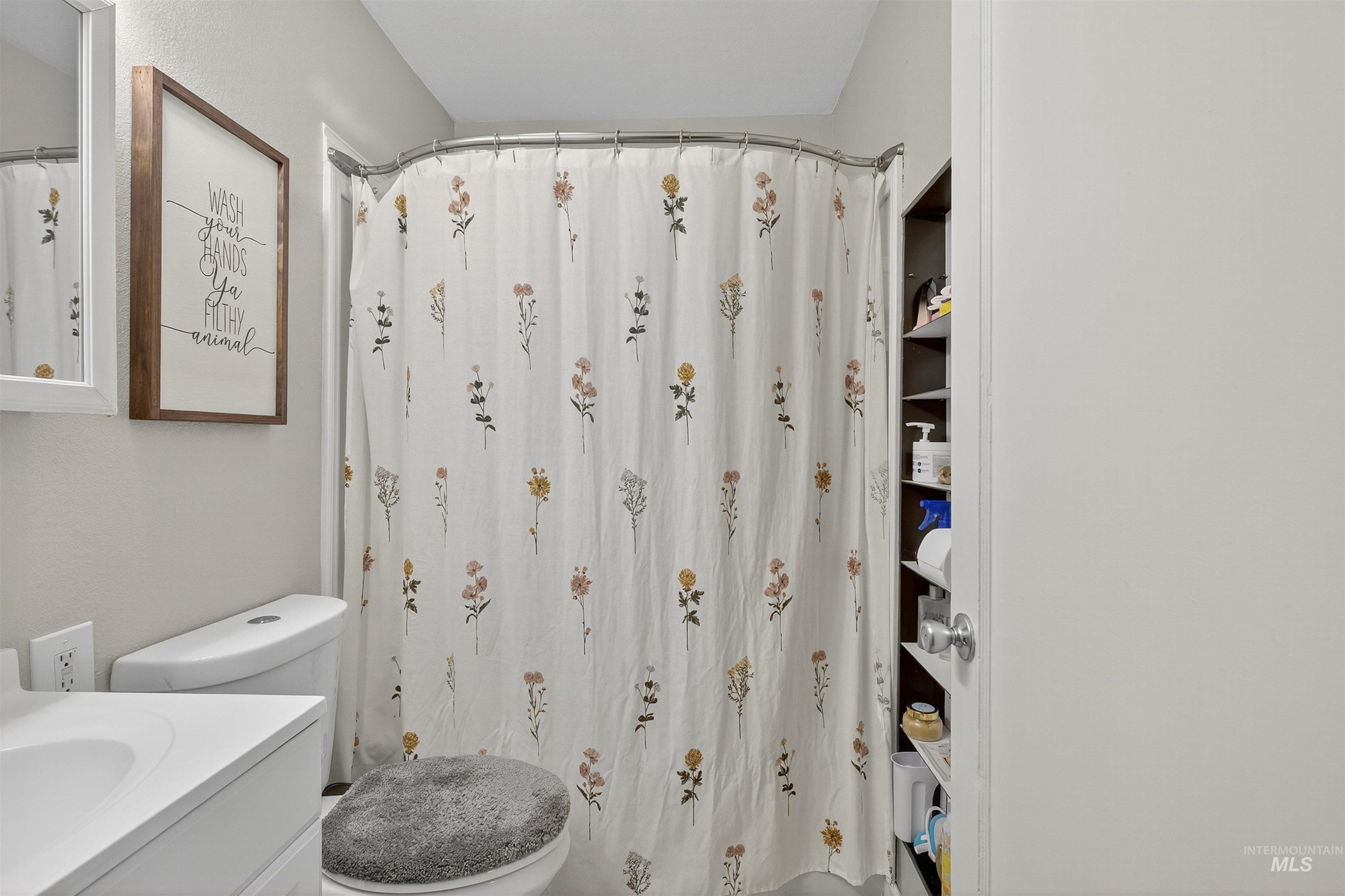 Full bath with vanity and a shower with shower curtain