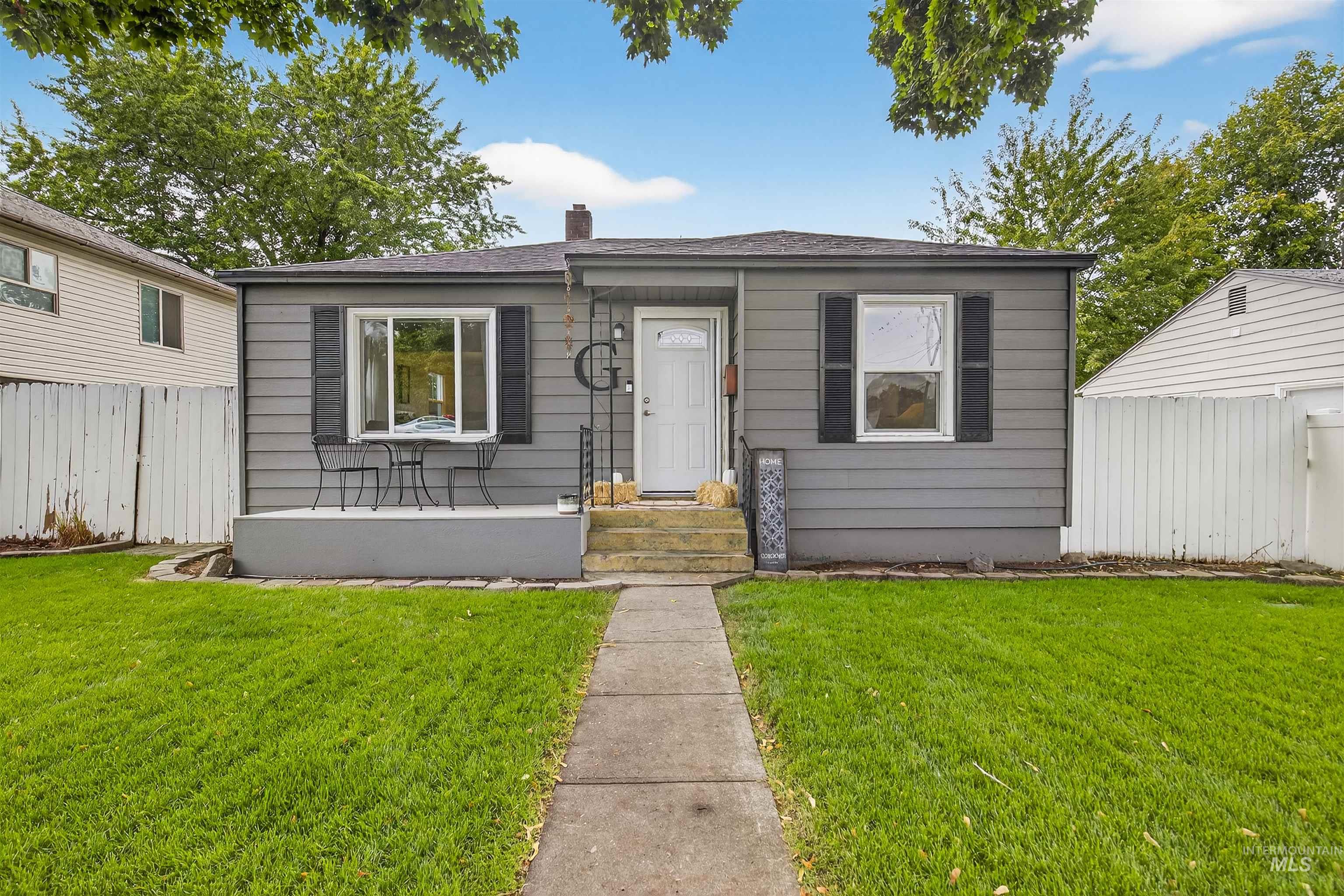 Bungalow with a chimney and a shingled roof