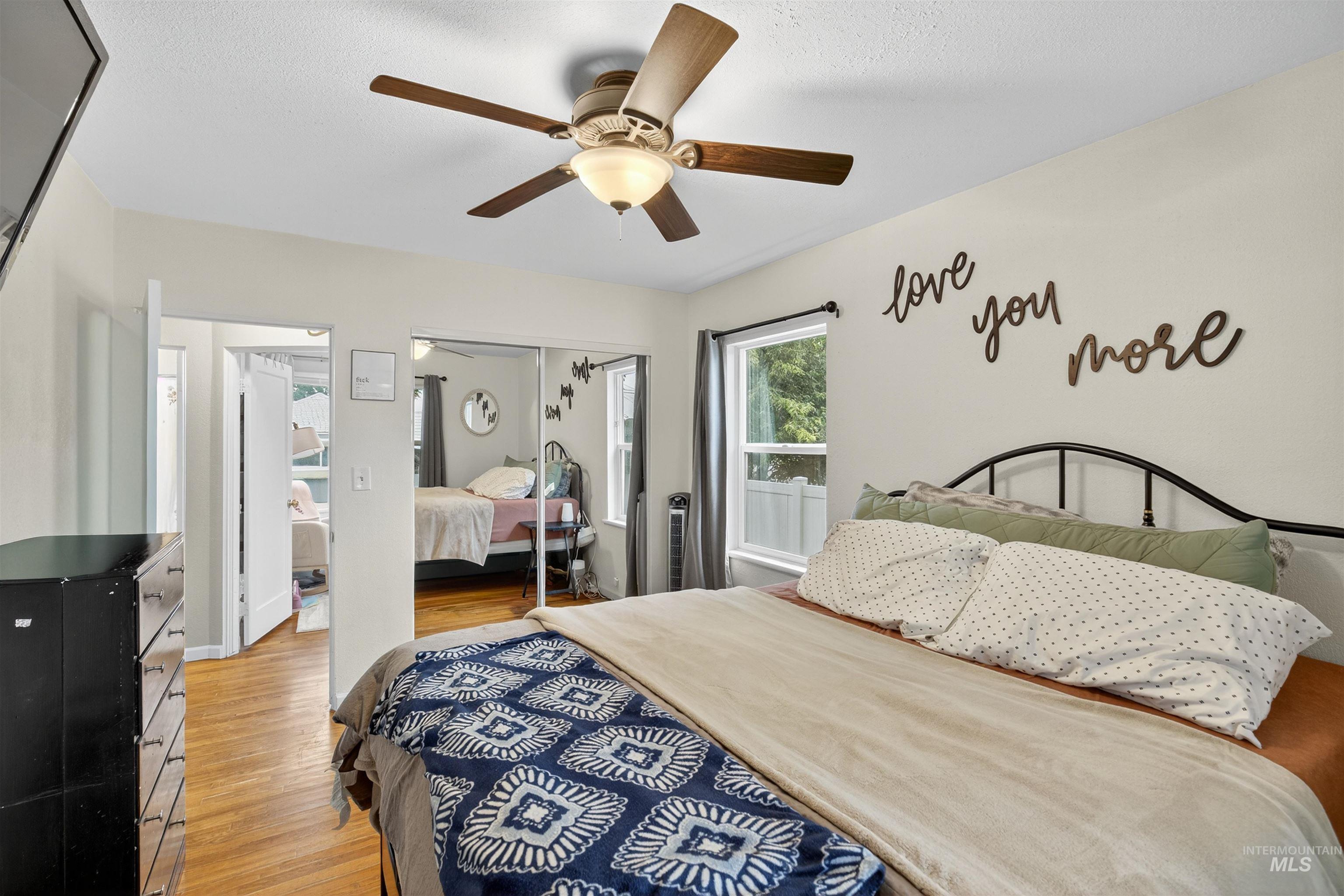 Bedroom featuring light wood-style flooring, a closet, and a ceiling fan