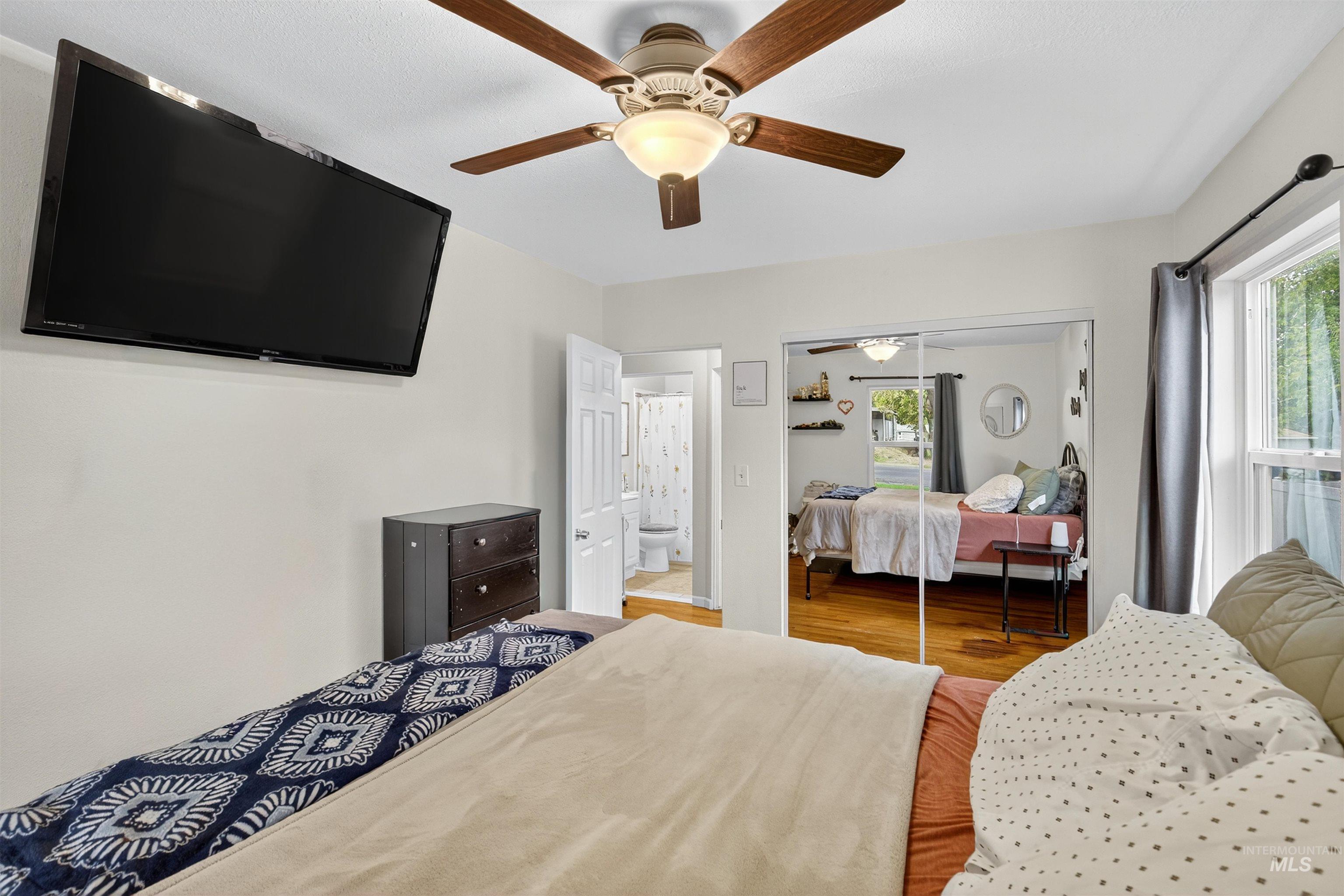 Bedroom featuring wood finished floors, ceiling fan, and a closet