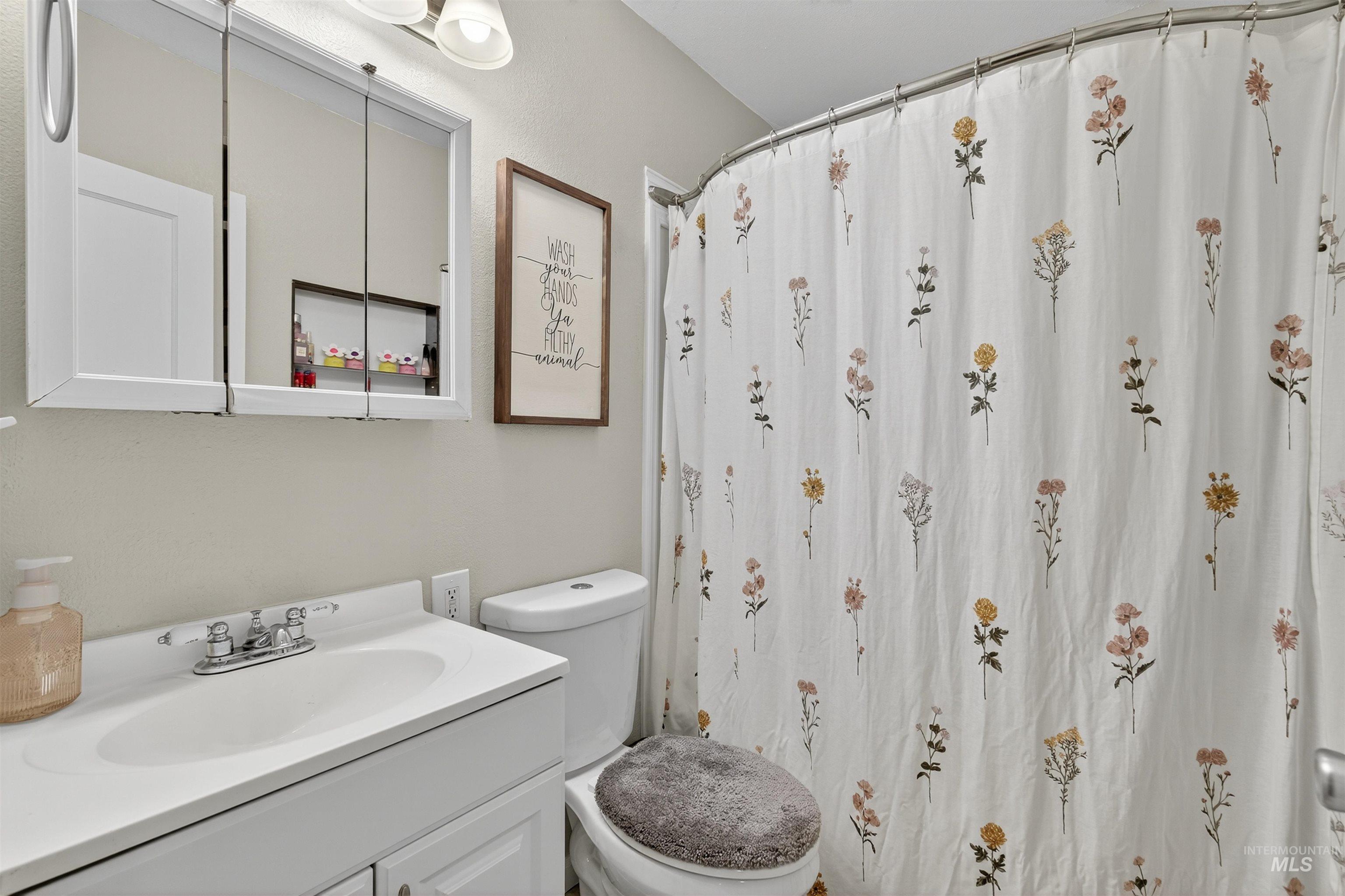 Bathroom featuring vanity and a stall shower