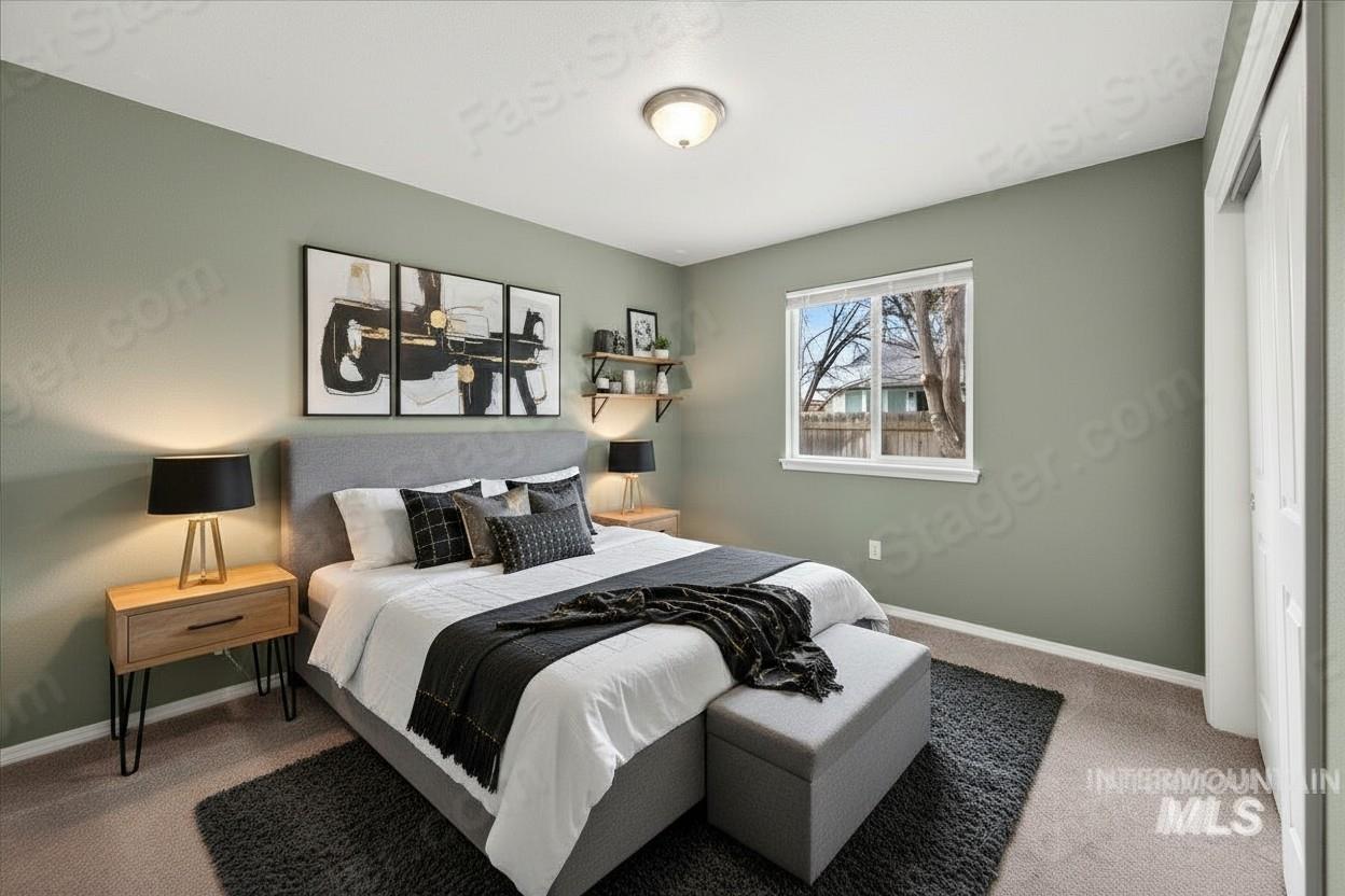Bedroom featuring carpet floors and baseboards