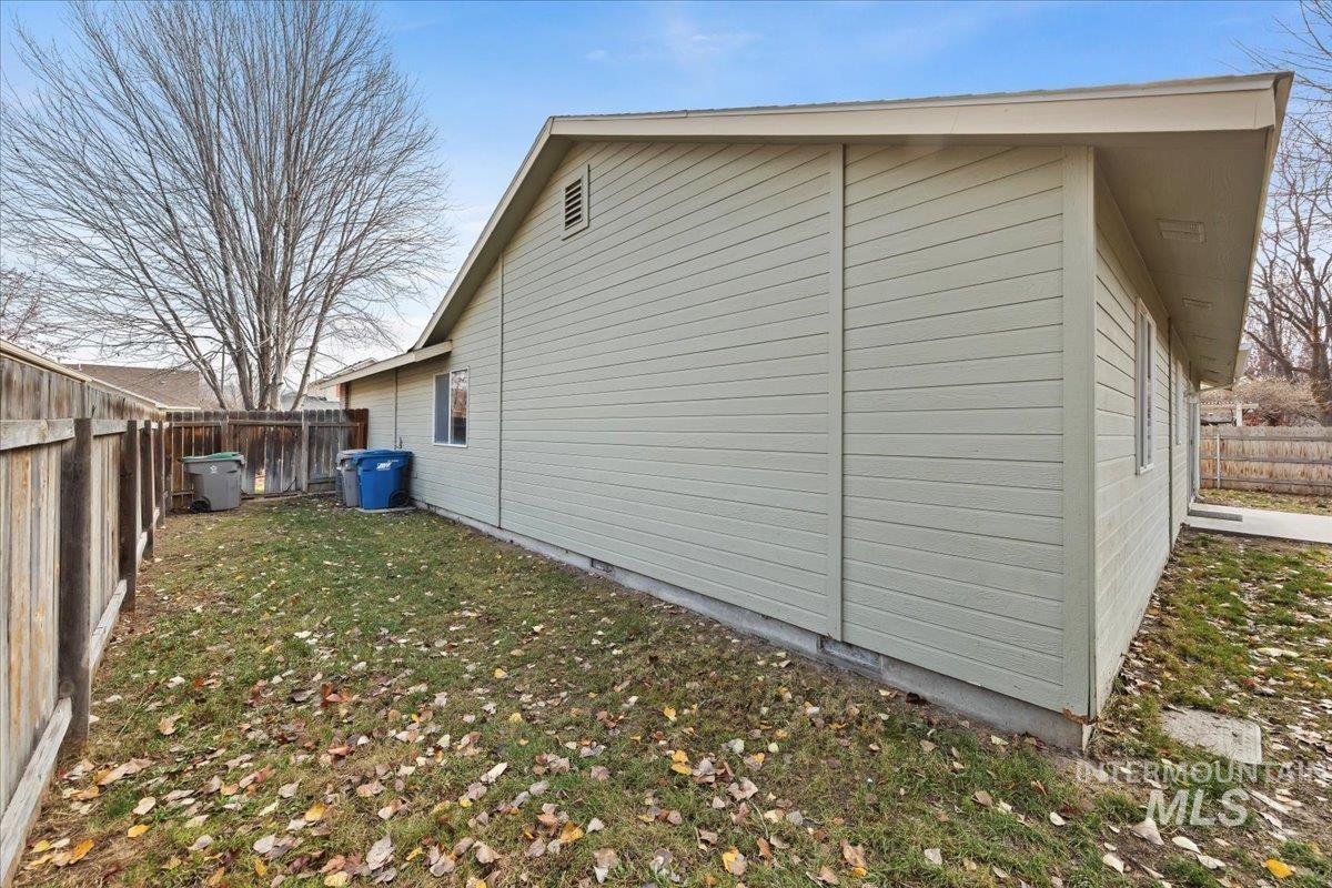 View of side of home featuring a fenced backyard