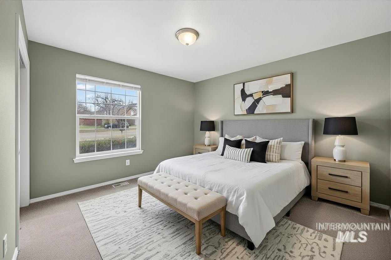 Carpeted bedroom featuring baseboards
