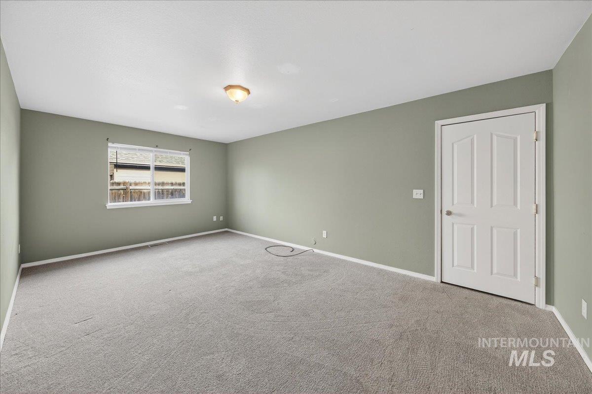Unfurnished room featuring carpet and baseboards