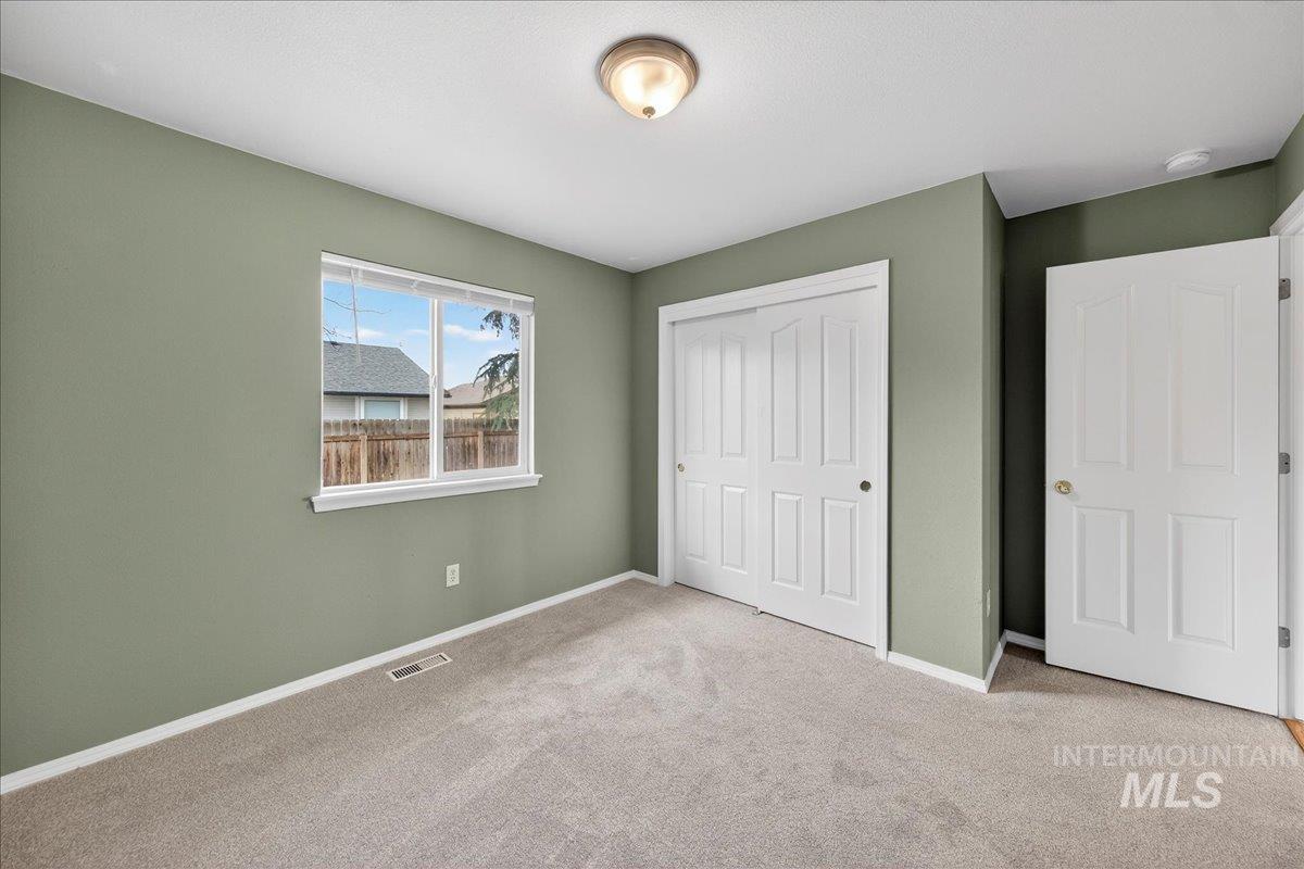 Unfurnished bedroom with carpet and a closet