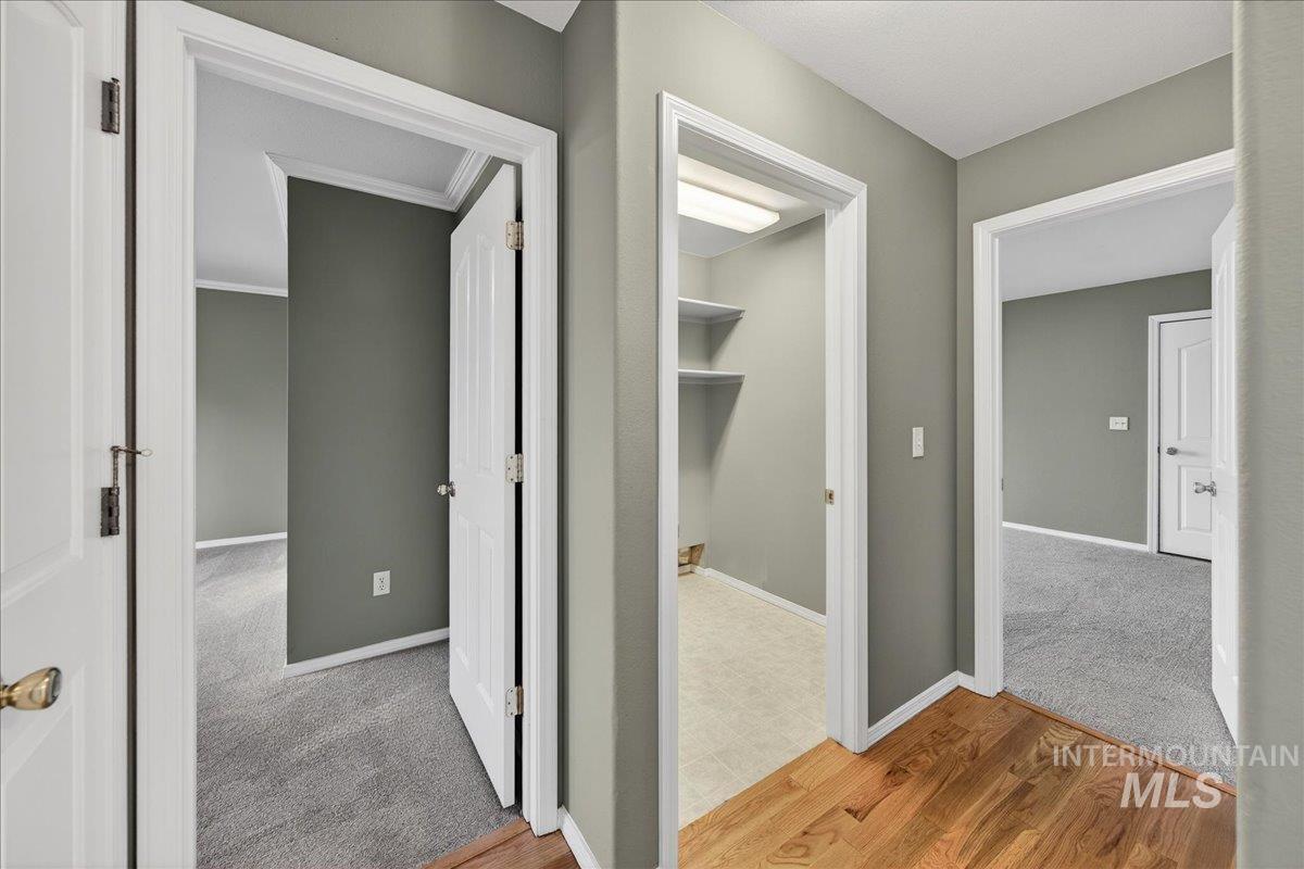 Hall with carpet floors and wood finished floors