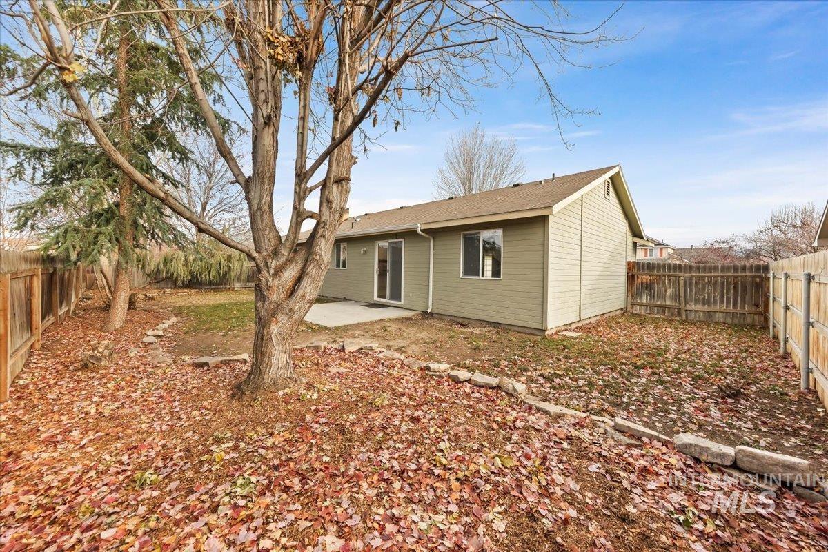 Back of property with a patio and a fenced backyard