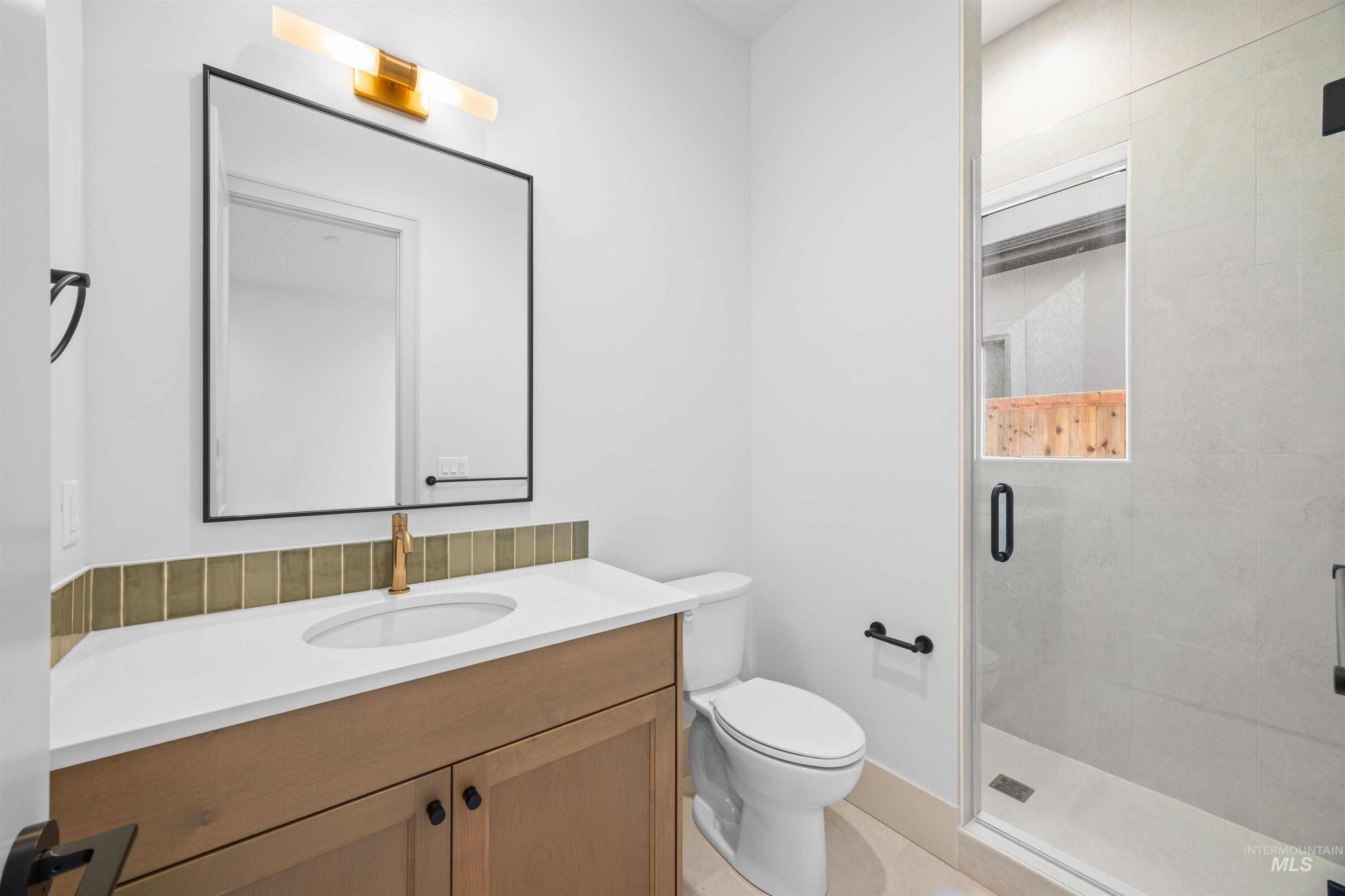 Full bathroom with vanity and a shower stall