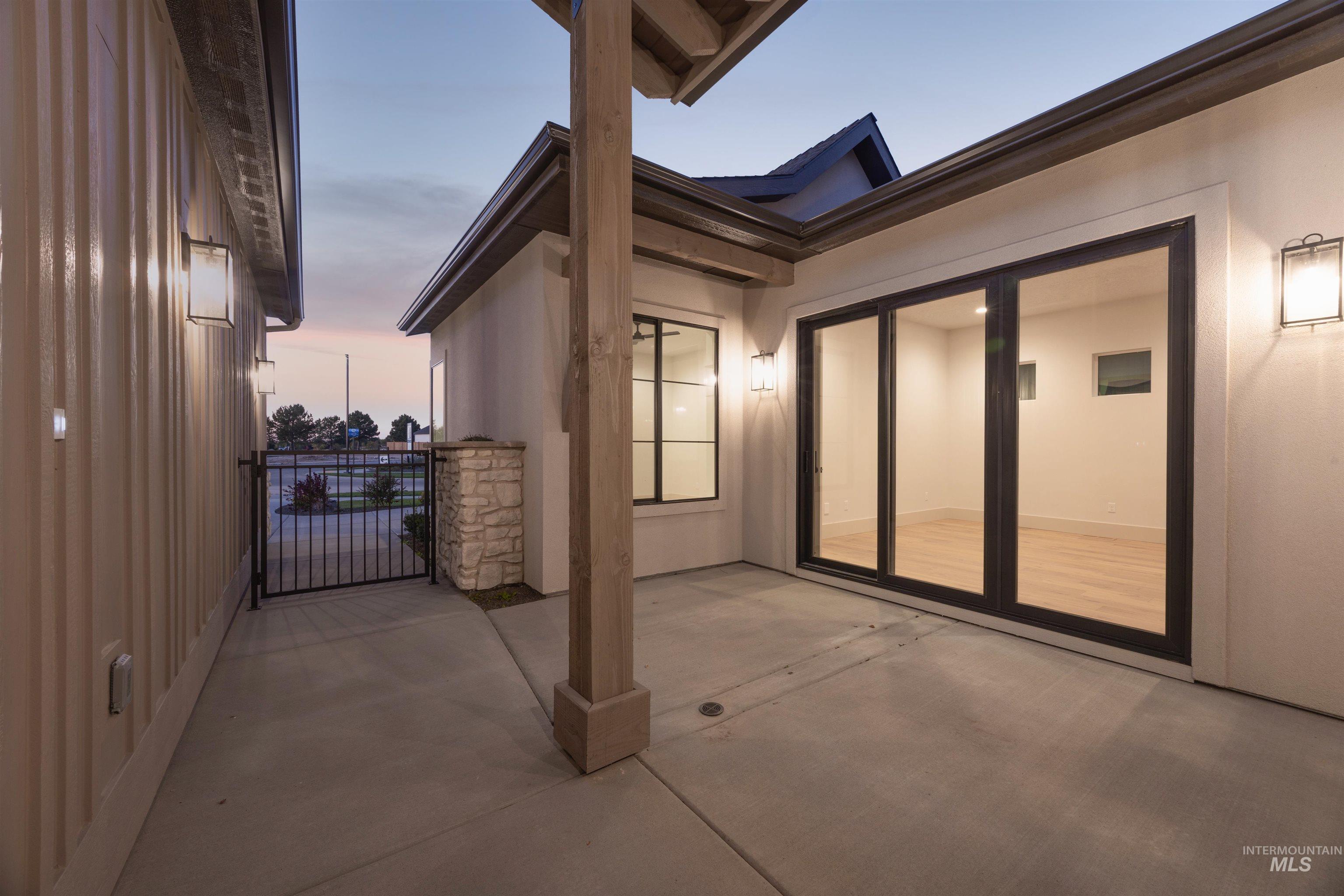View of patio featuring a gate