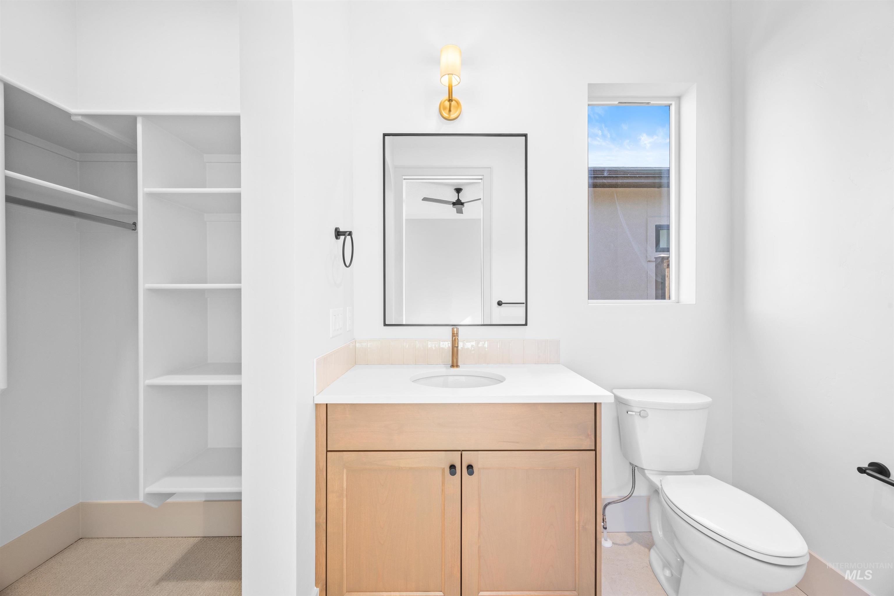Half bathroom with vanity and toilet