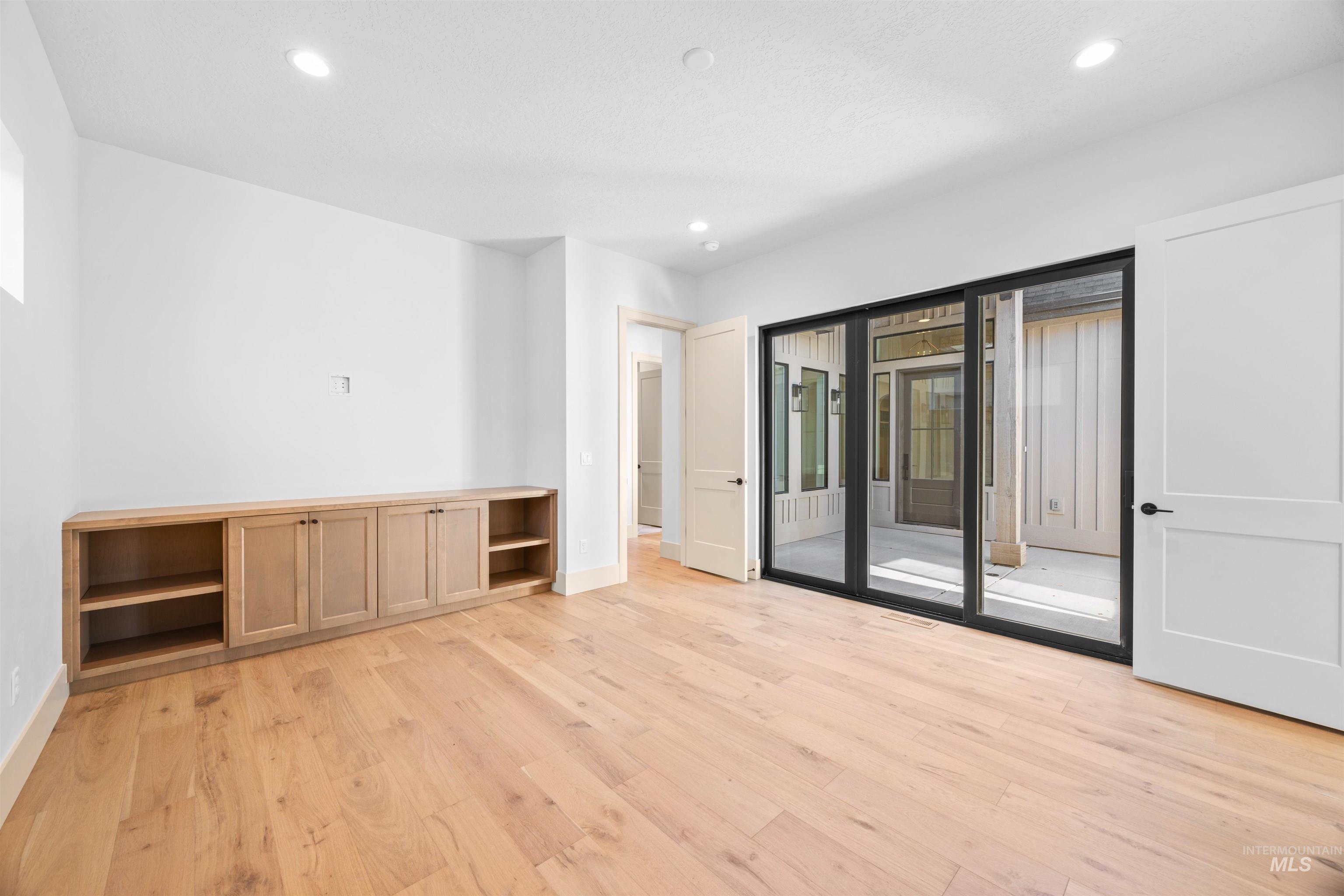 Unfurnished room with light wood finished floors, recessed lighting, and plenty of natural light