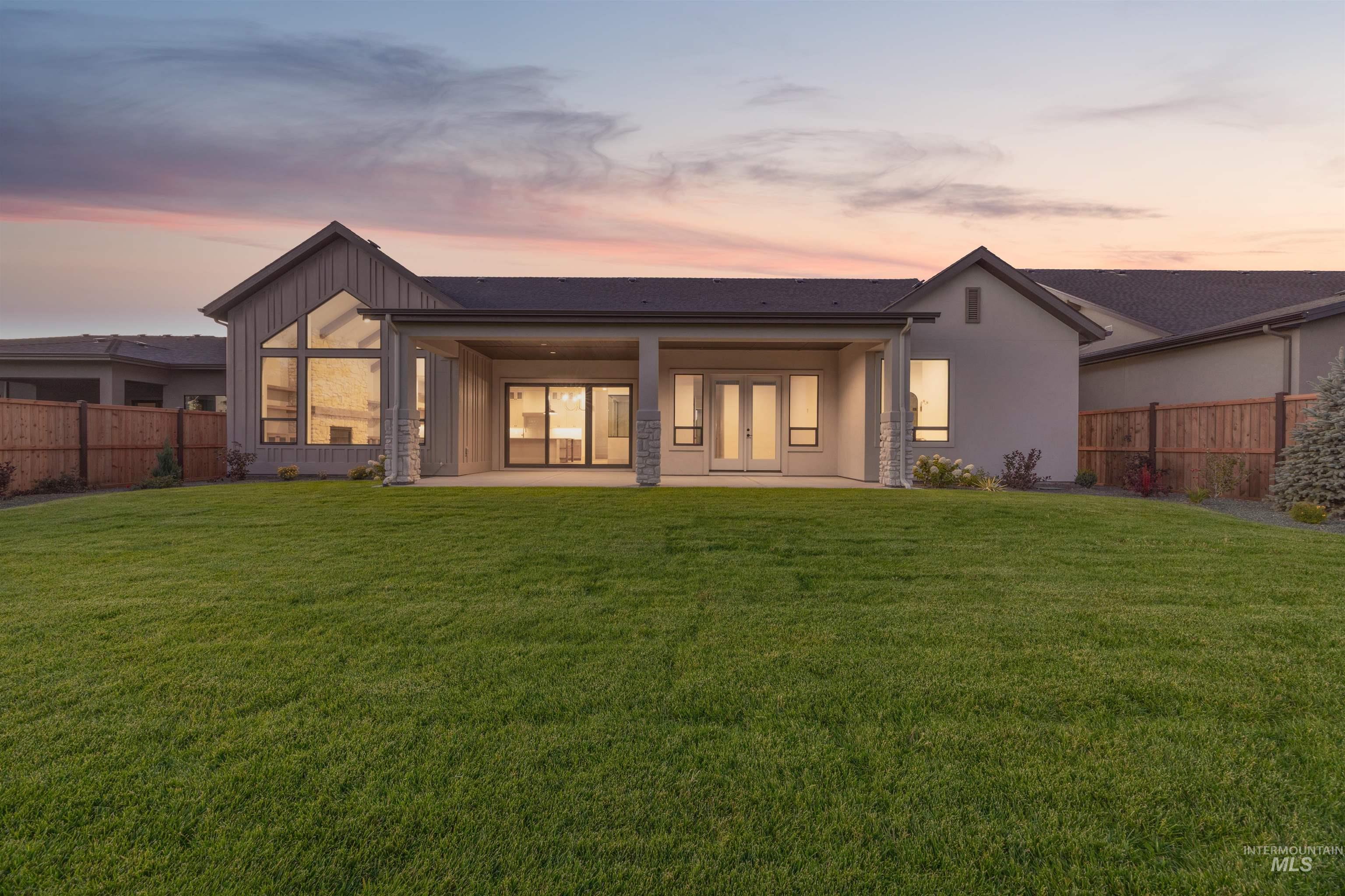 Back of house featuring a patio area and board and batten siding