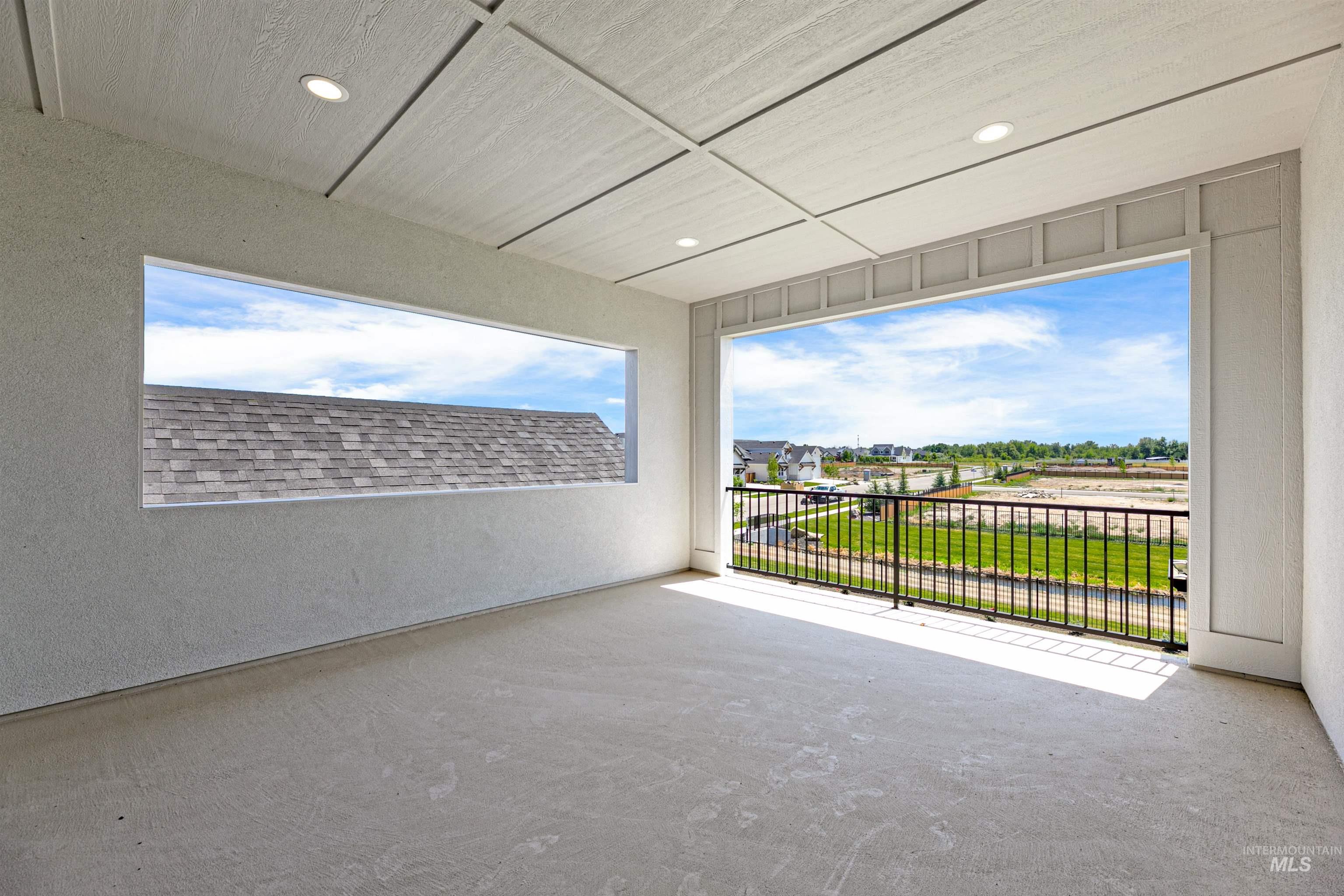 Unfurnished room with recessed lighting, a textured wall, and unfinished concrete floors