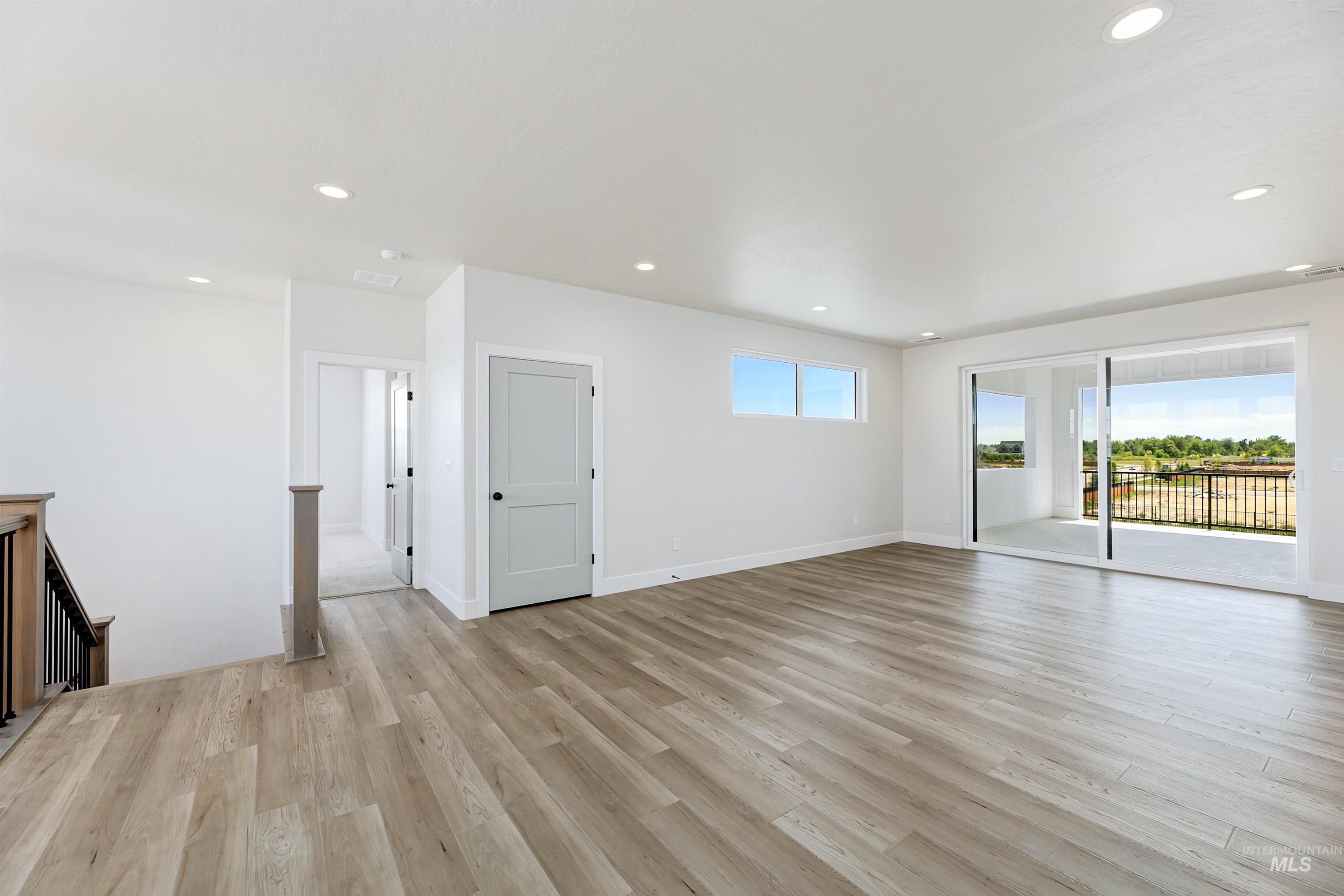 Unfurnished living room with recessed lighting and light wood-style floors