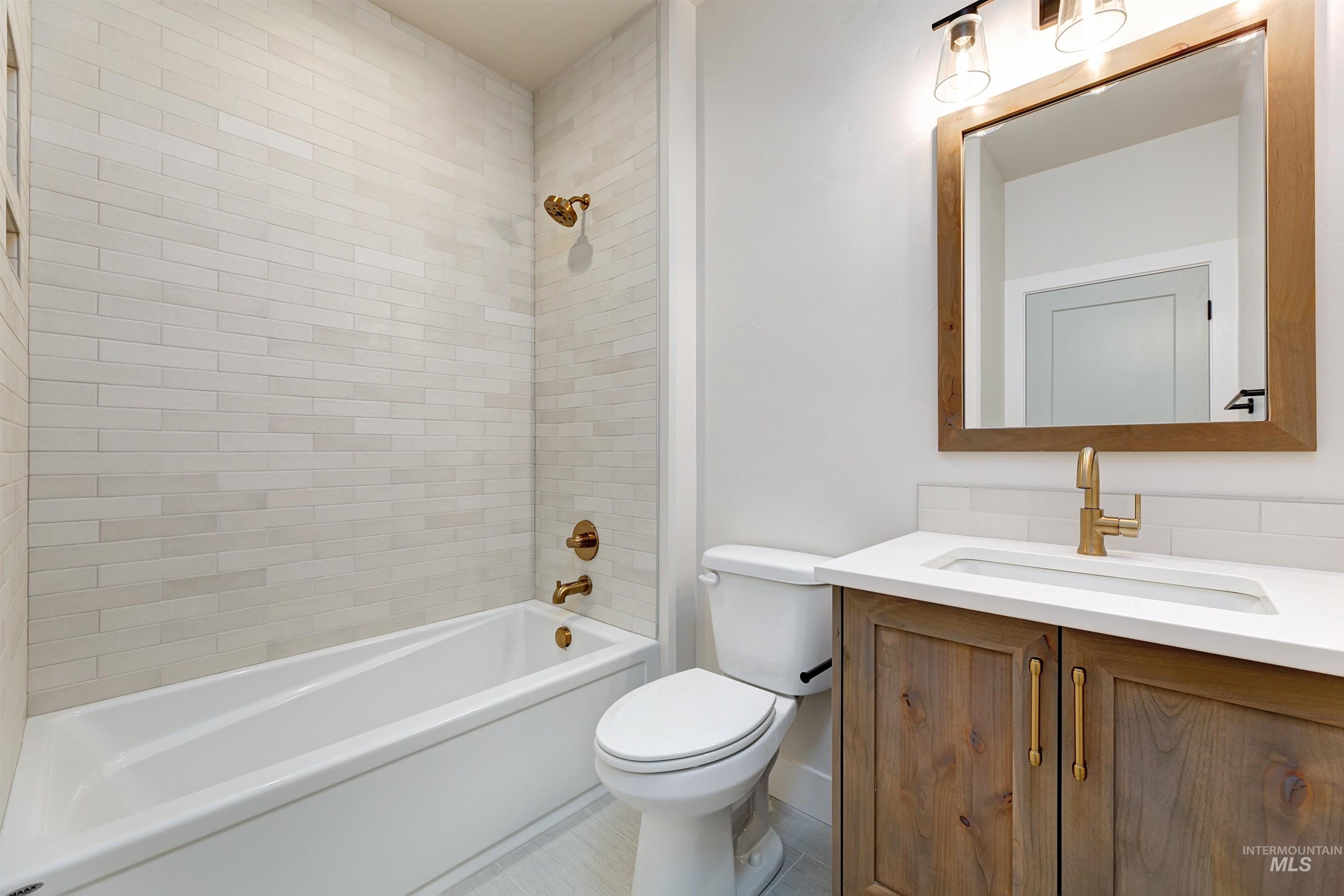 Bathroom featuring vanity and shower / bathtub combination
