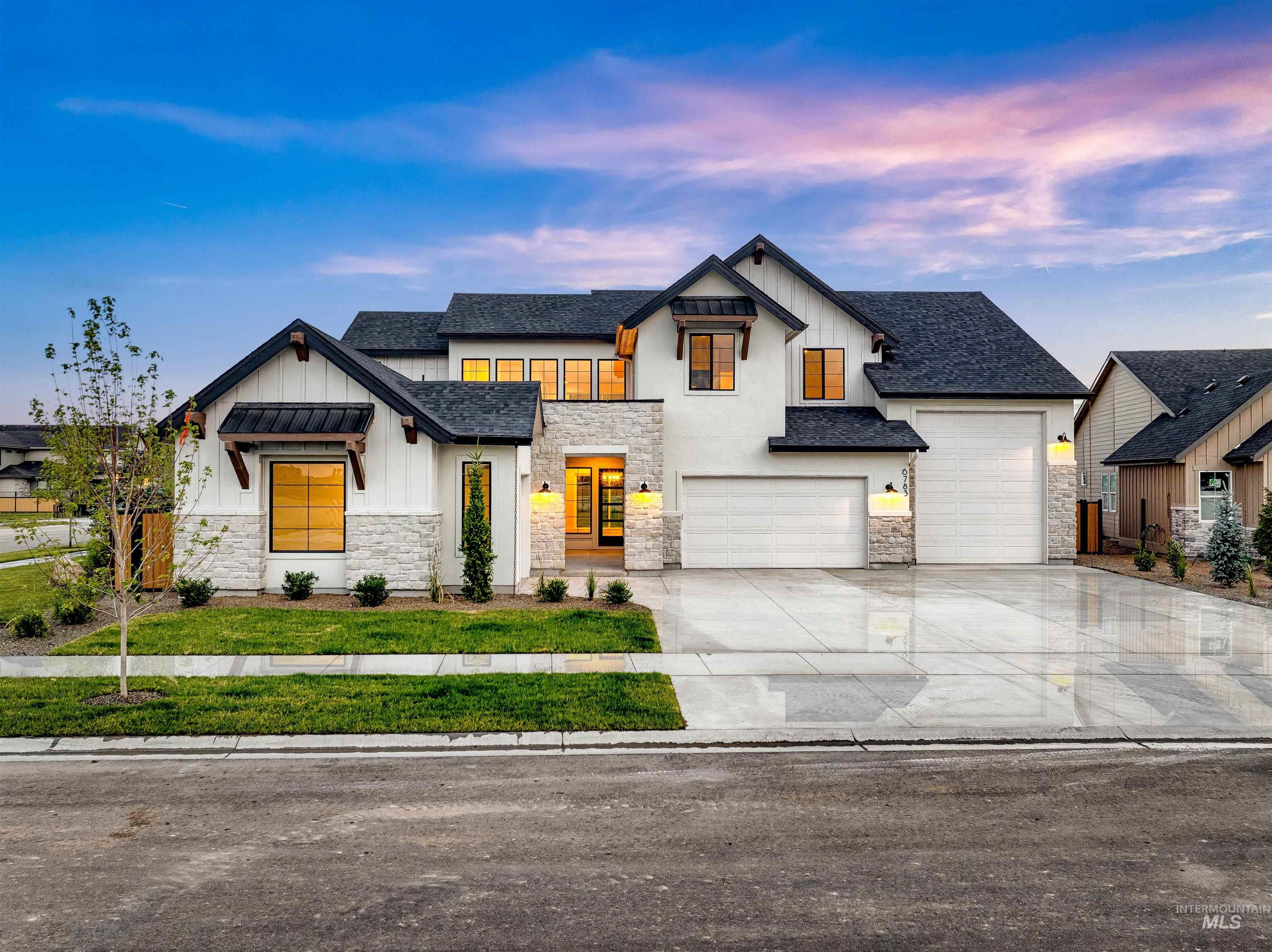 Modern inspired farmhouse with board and batten siding, driveway, a shingled roof, and a front yard