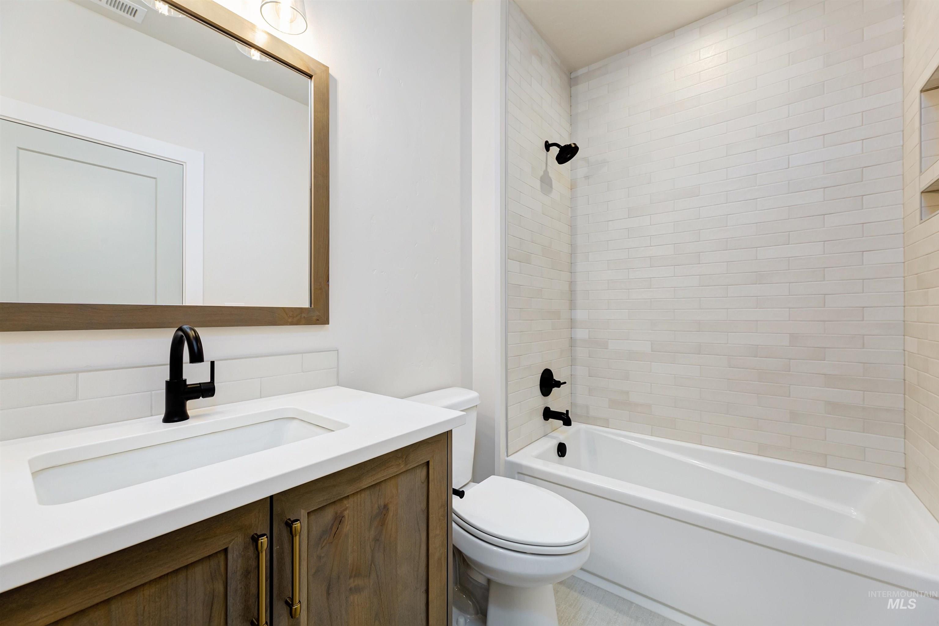 Bathroom with vanity and bathing tub / shower combination