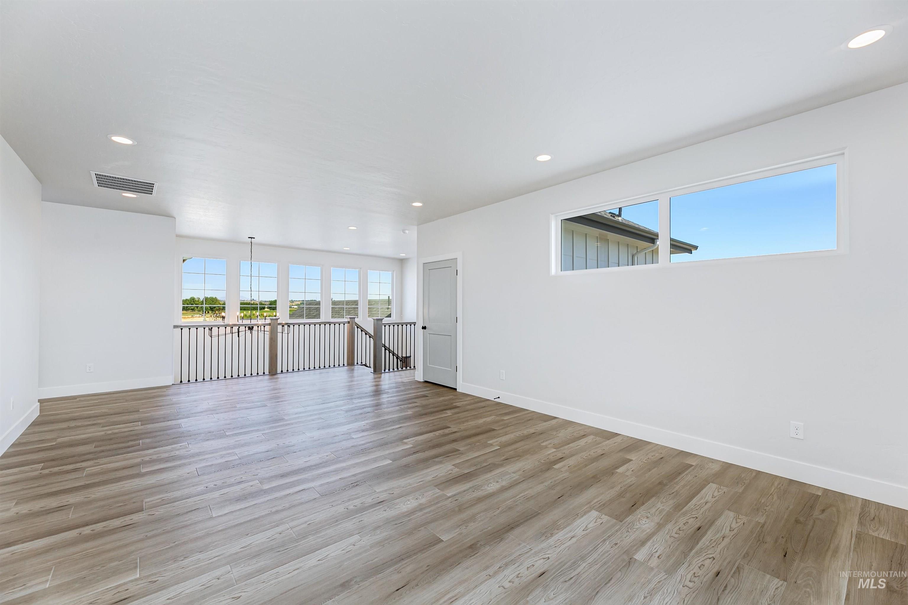 Spare room with recessed lighting and light wood-style flooring
