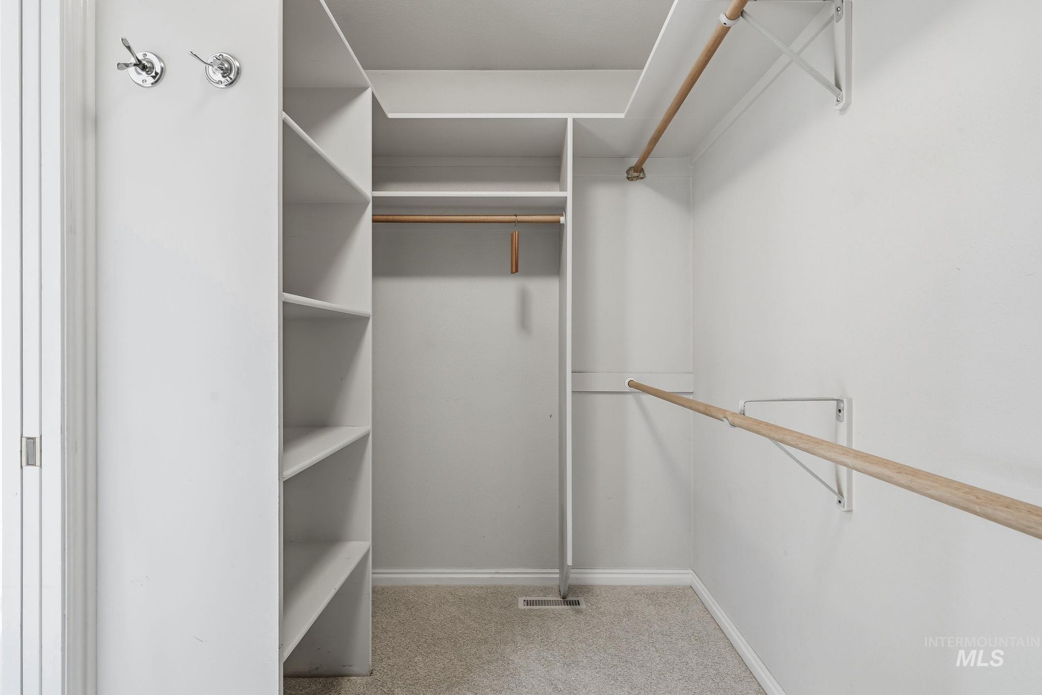 Built-in closet system with multiple shelving units and hanging rods