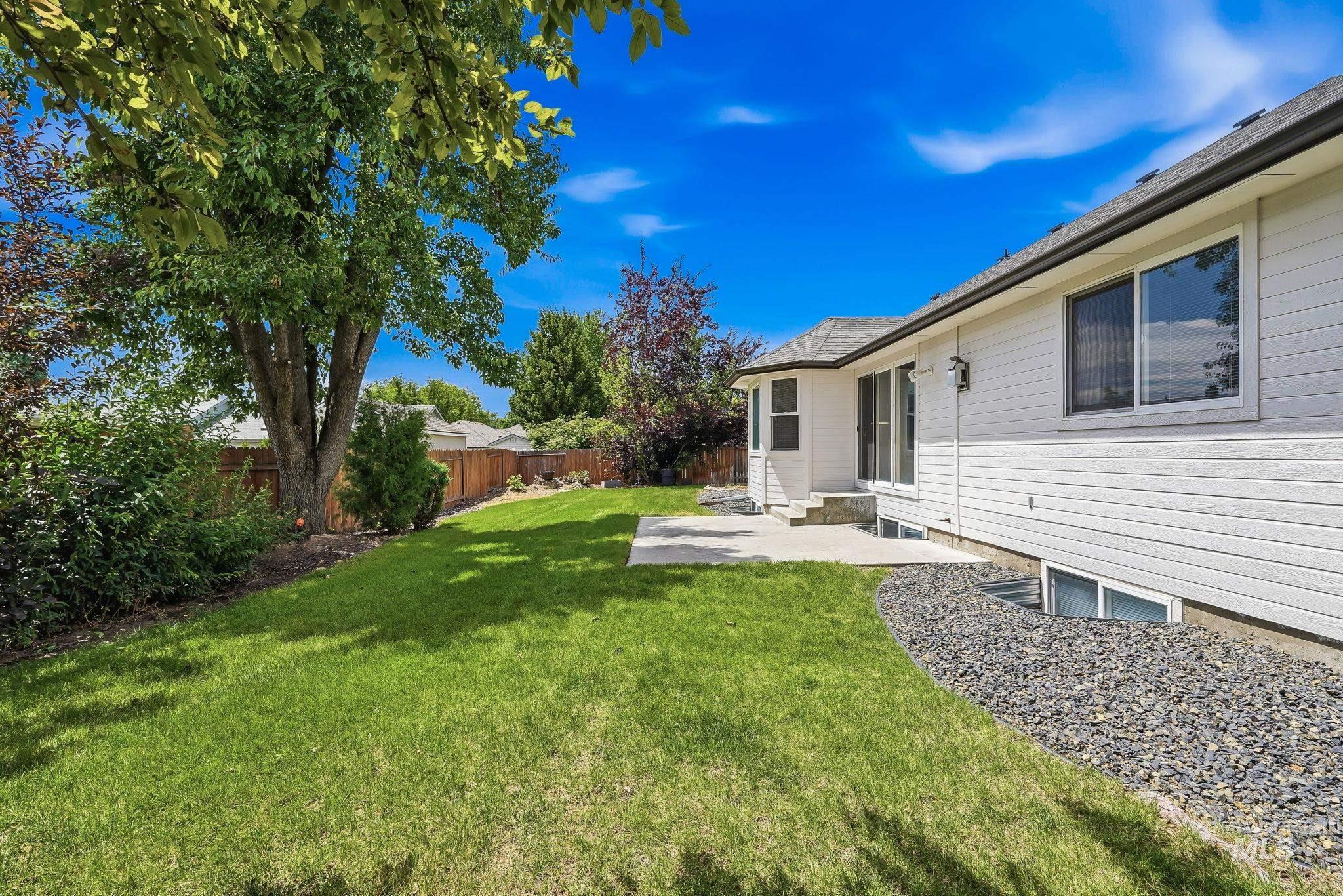 Expansive lawn with mature trees and established landscaping