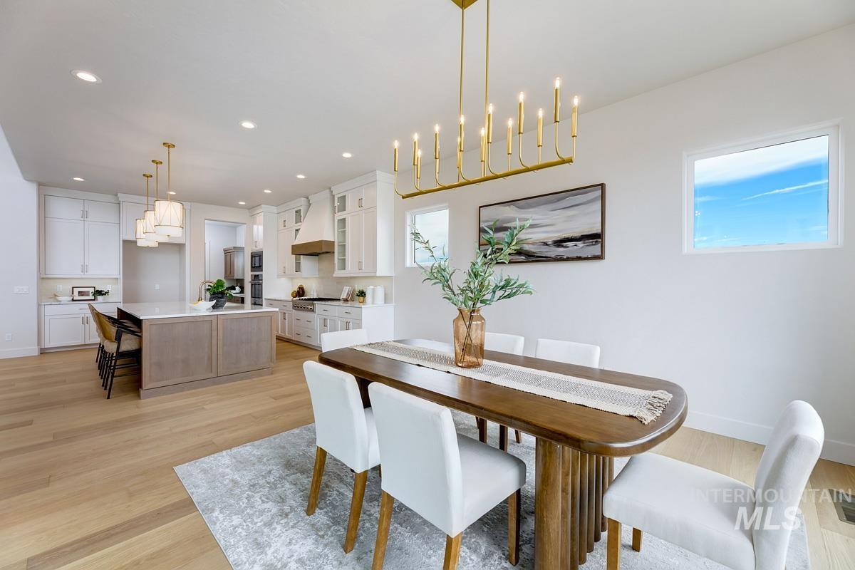 Dining area featuring light wood-style flooring, a chandelier, and recessed lighting