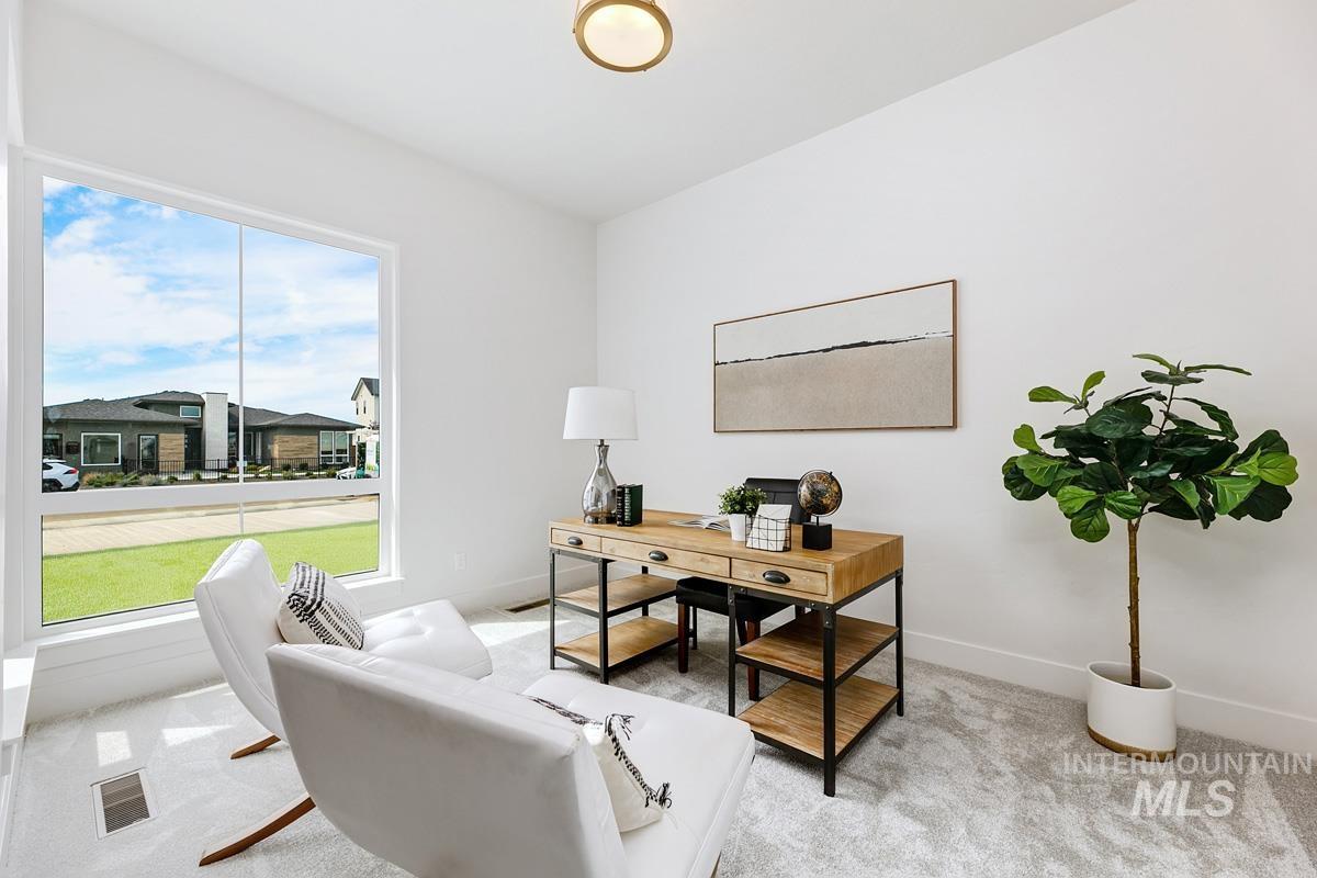 Office space with light carpet and baseboards