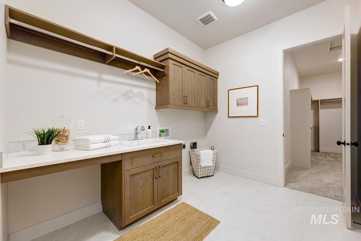 Laundry room with hookup for a washing machine and cabinet space