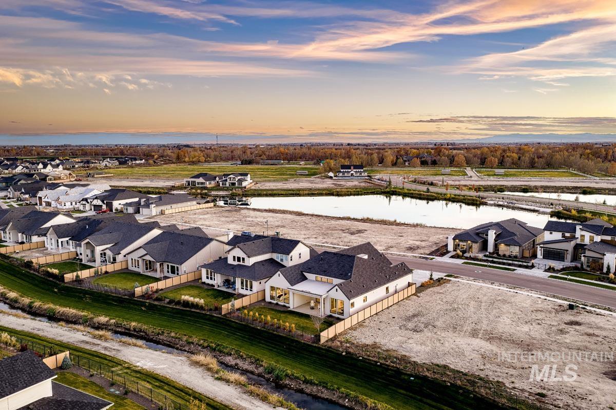 Aerial view at dusk of a water view and a residential view