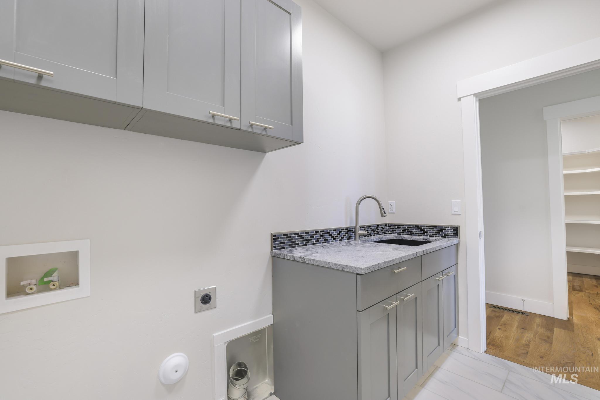 Laundry room with cabinet space, washer hookup, and hookup for an electric dryer