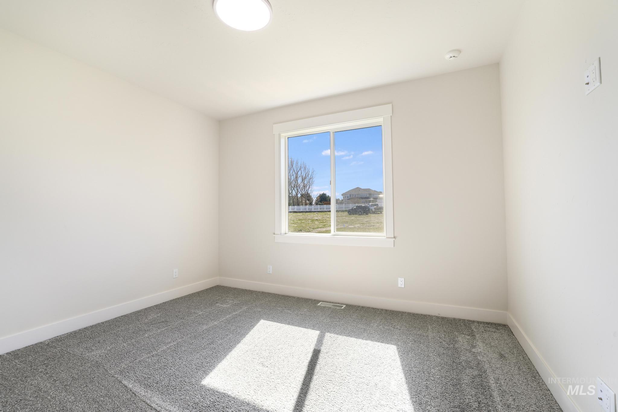 Spare room with carpet floors and baseboards