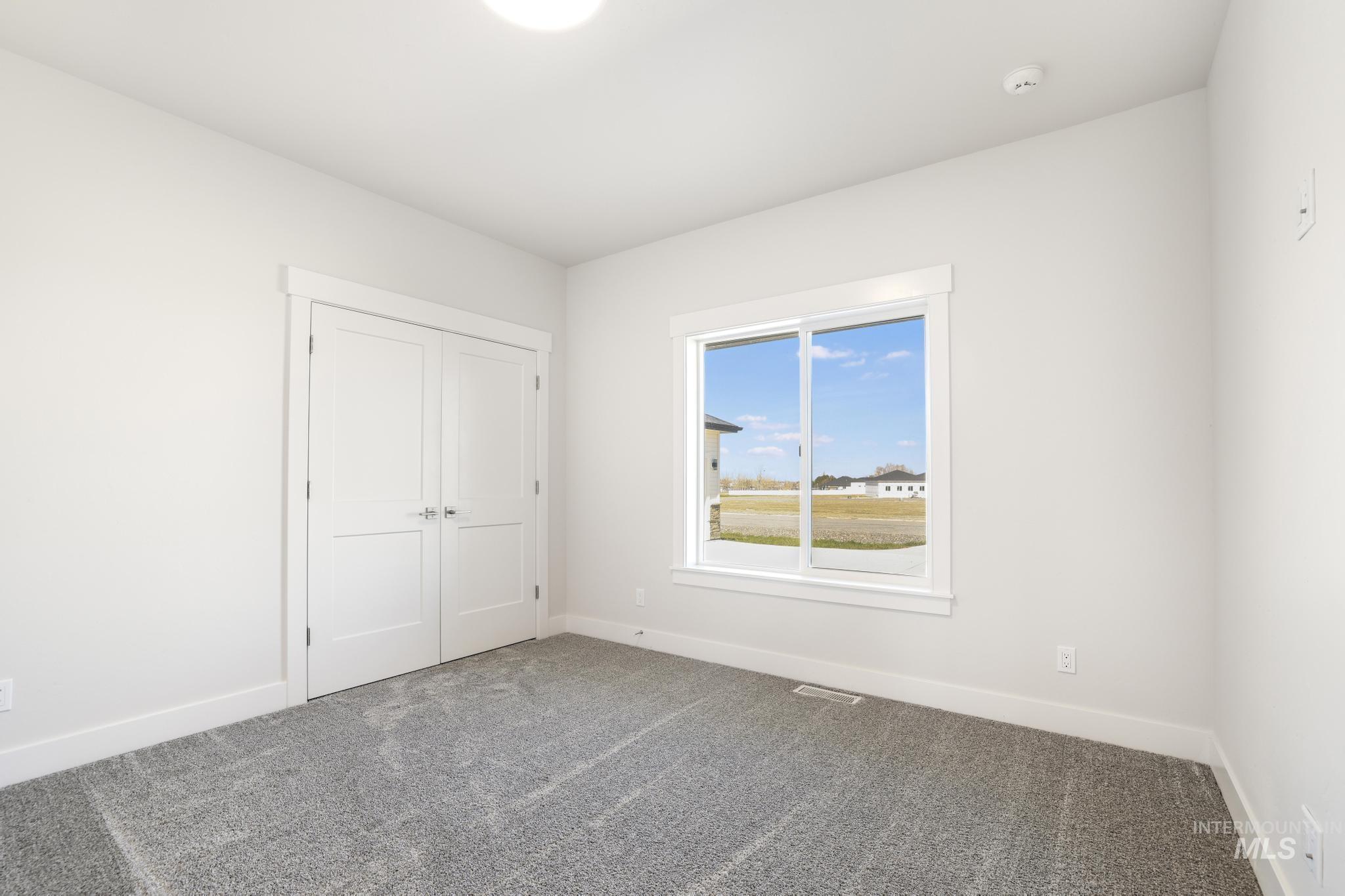 Unfurnished bedroom with carpet flooring and a closet