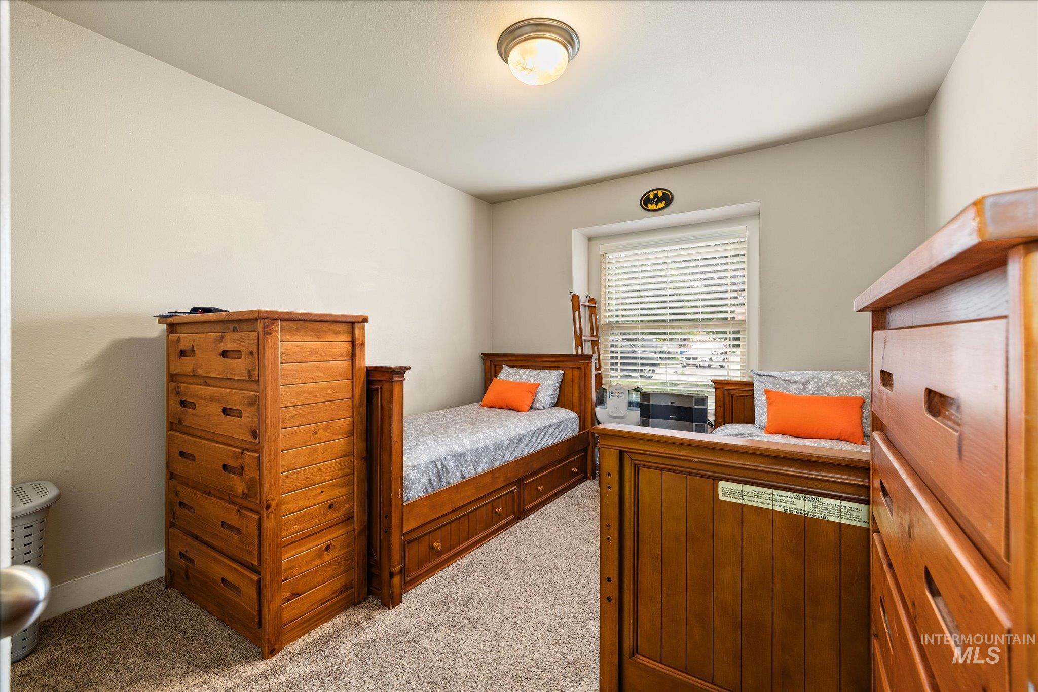 Bedroom featuring light colored carpet