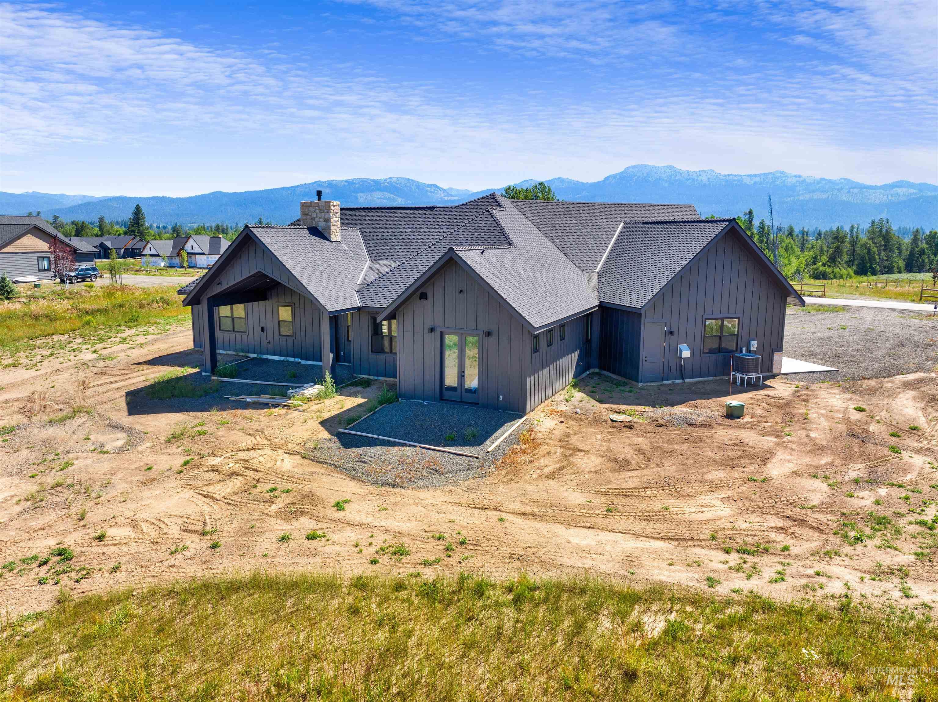 View of front of property with board and batten siding, a mountain view, and a chimney