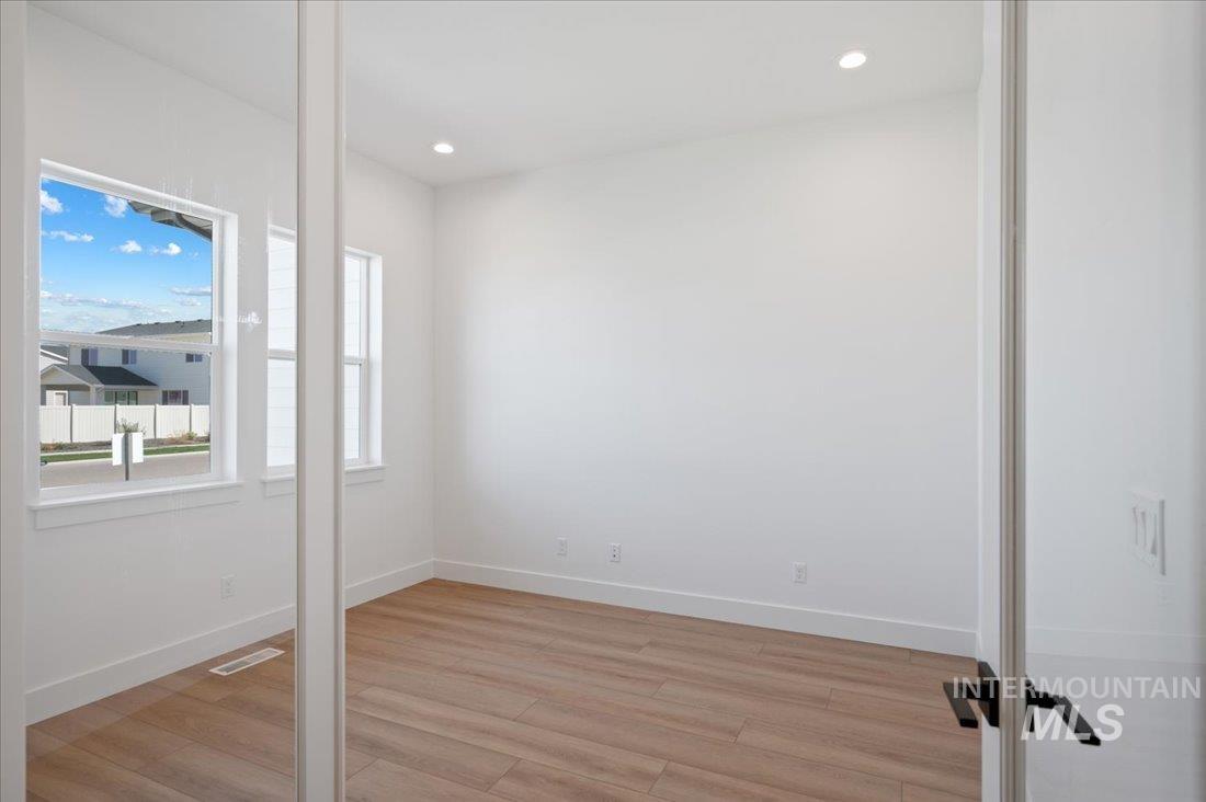 Unfurnished room with light wood finished floors and recessed lighting