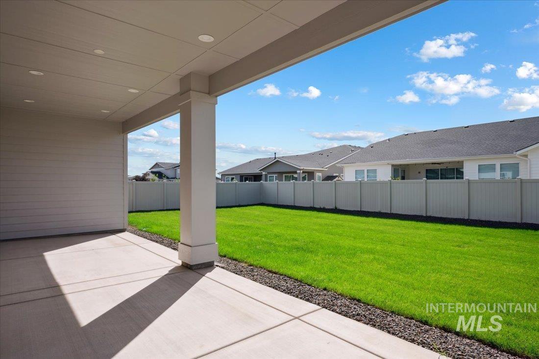 Fenced backyard with a patio area